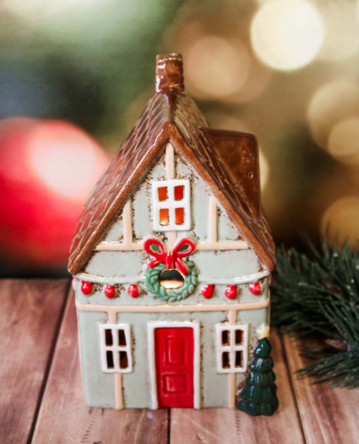 Hand painted holiday ceramic village houses with christmas trees, wreaths, bows, and lights with back open for candles and faux lights for sale at the rustic barn in Killingworth, CT
