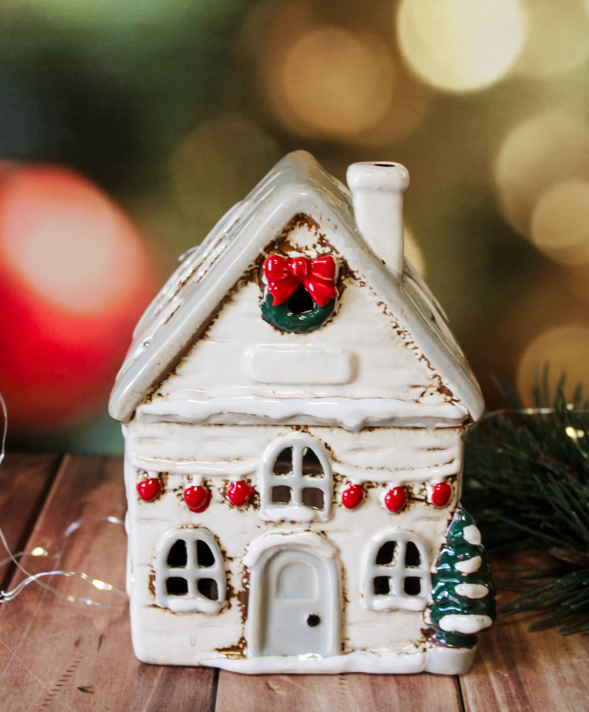 Hand painted holiday ceramic village houses with christmas trees, wreaths, bows, and lights with back open for candles and faux lights for sale at the rustic barn in Killingworth, CT