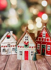 Hand painted holiday ceramic village houses with christmas trees, wreaths, bows, and lights with back open for candles and faux lights for sale at the rustic barn in Killingworth, CT