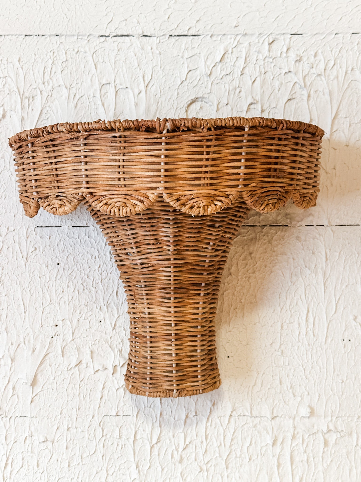 hand woven rattan scalloped wall shelf at the rustic barn in killingworth ct