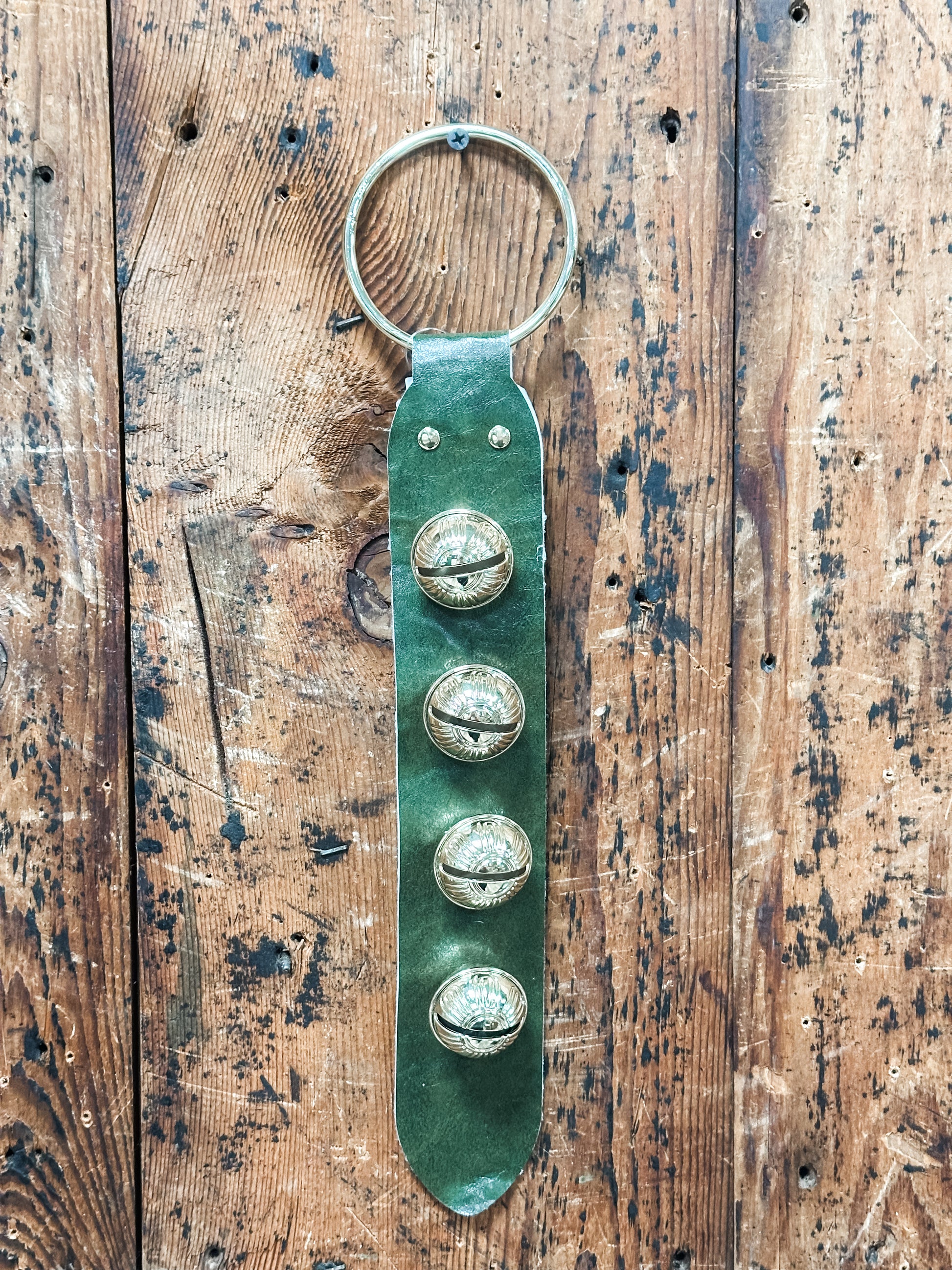 leather and embosses metal bells door hanger at The Rustic Barn in Killingworth CT