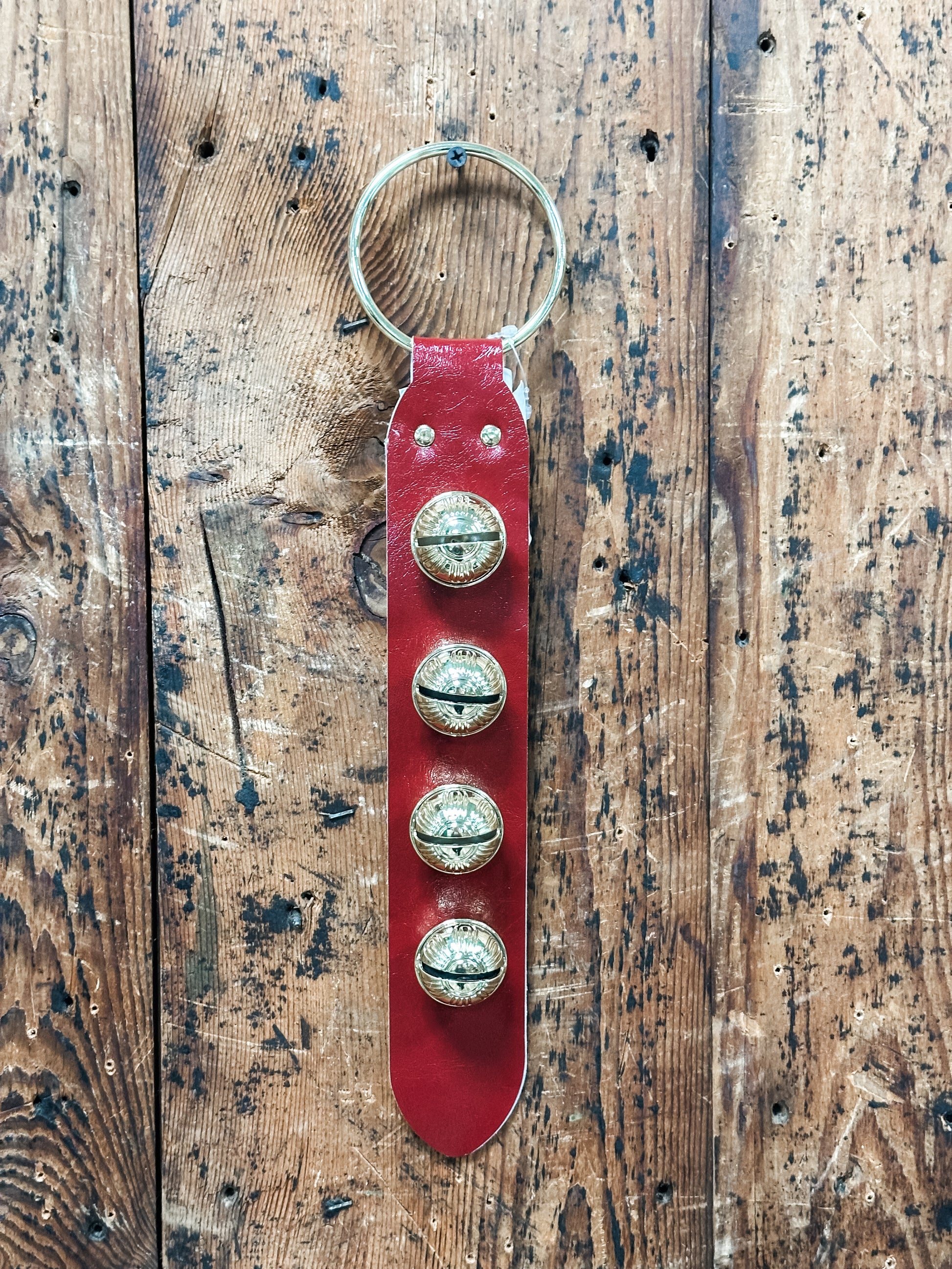 leather and embosses metal bells door hanger at The Rustic Barn in Killingworth CT