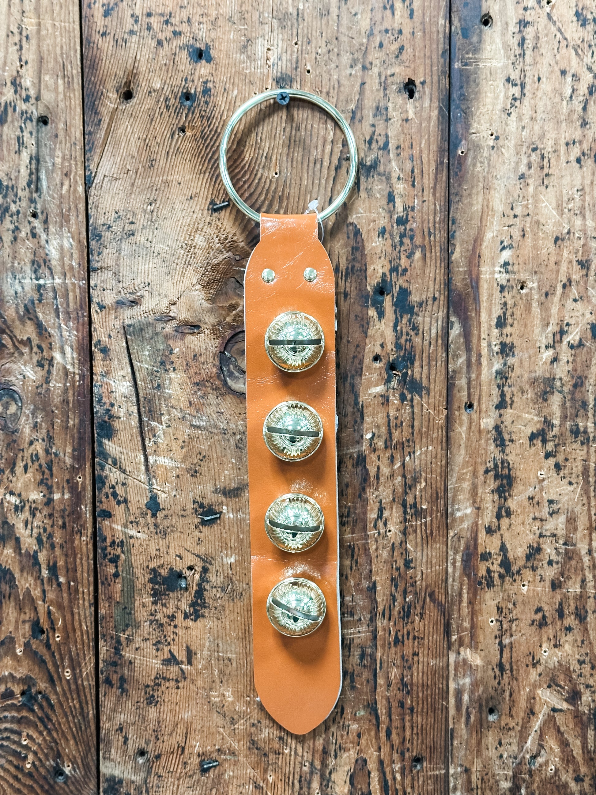 leather and embosses metal bells door hanger at The Rustic Barn in Killingworth CT