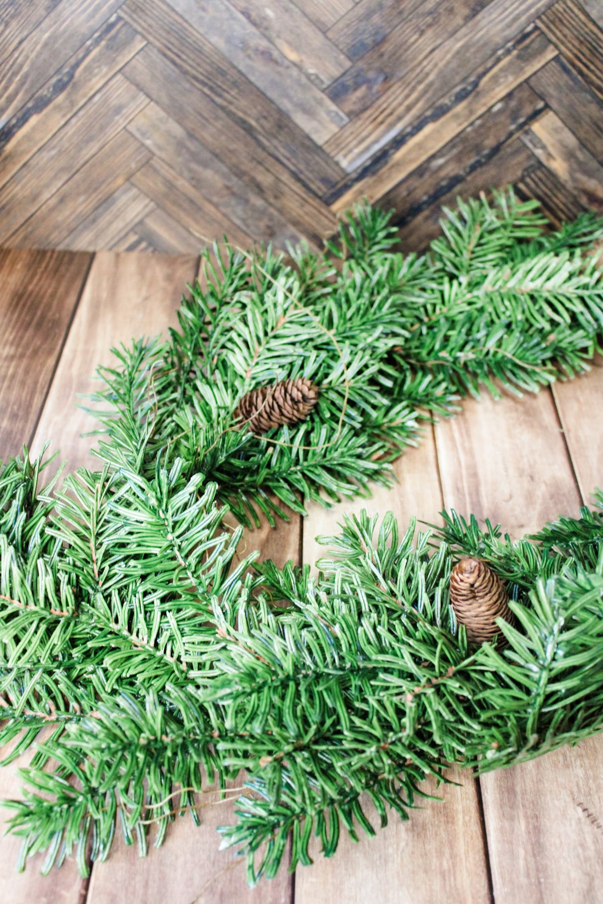 Luxe glacier snow frosted winter garland with pinecones for christmas for sale at the rustic barn in Killingworth, CT