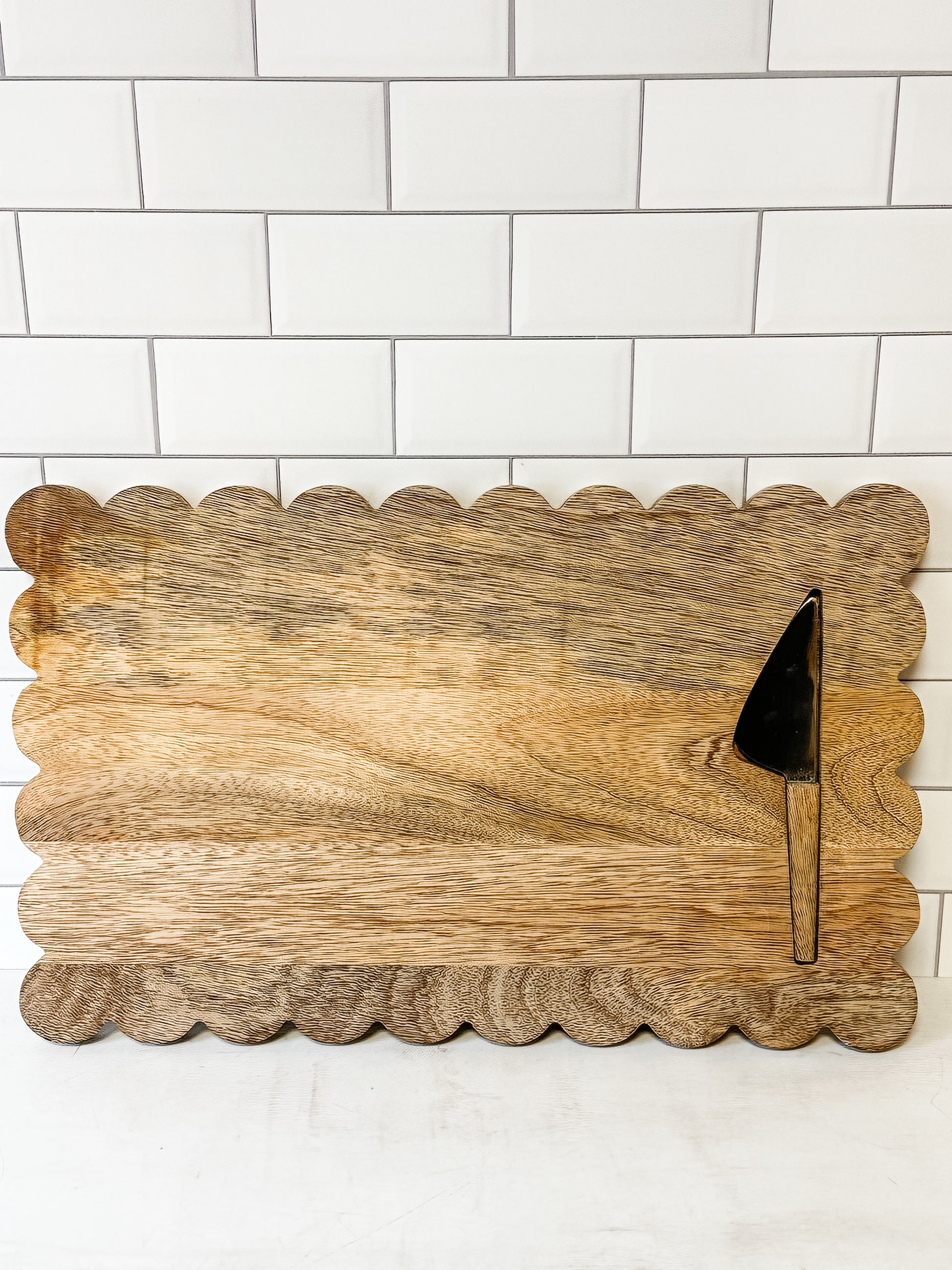 mango wood scalloped cheese and serving board with knife at the Rustic Barn in Killingworth CT