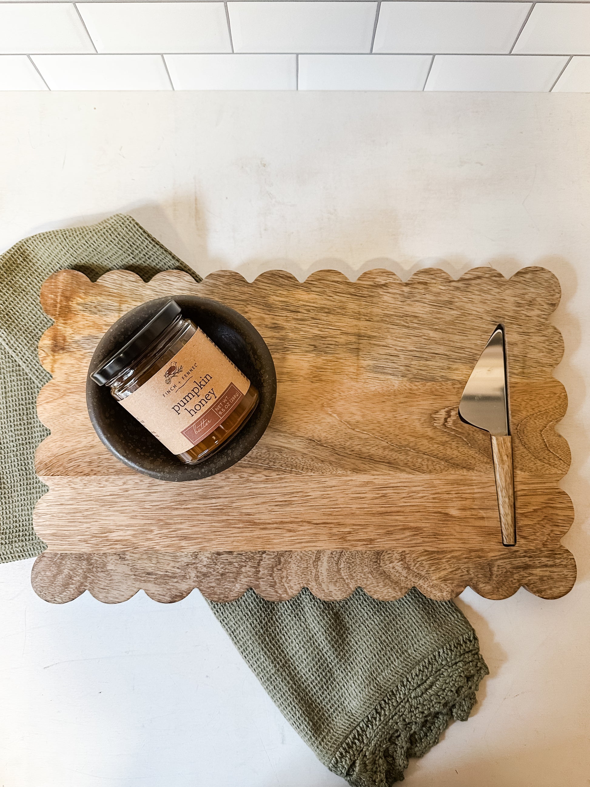 mango wood scalloped cheese and serving board with knife at the Rustic Barn in Killingworth CT