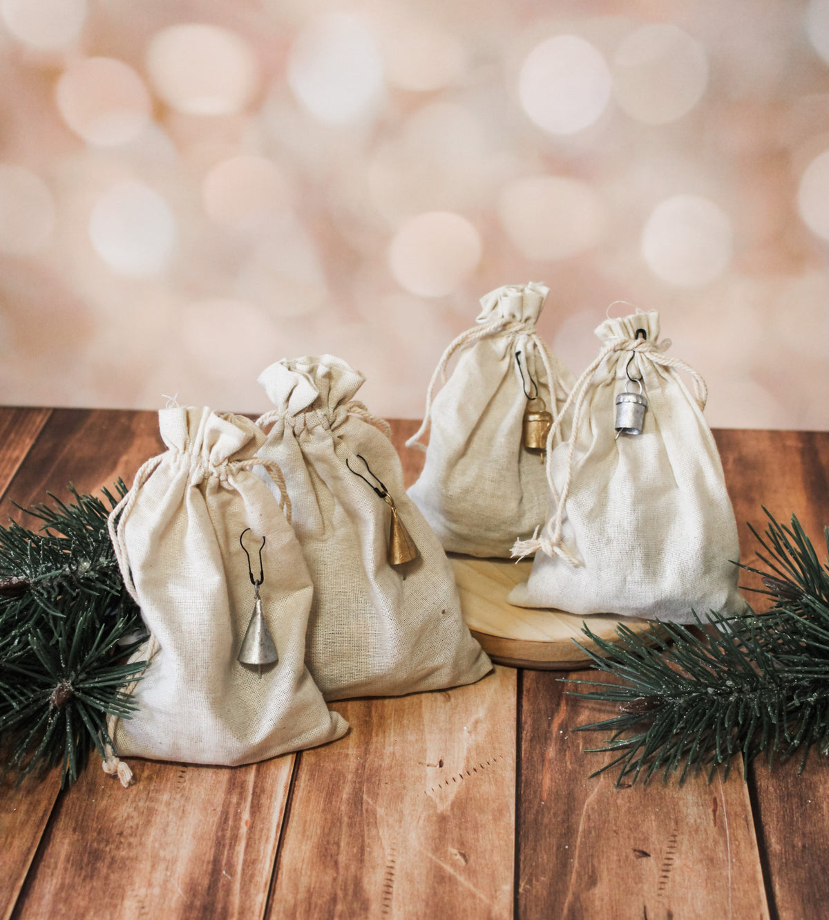 metal mini decorative bells for christmas silver and gold in drawstring cream bags for the holidays tiny decorative bells for sale at the rustic barn in Killingworth, CT