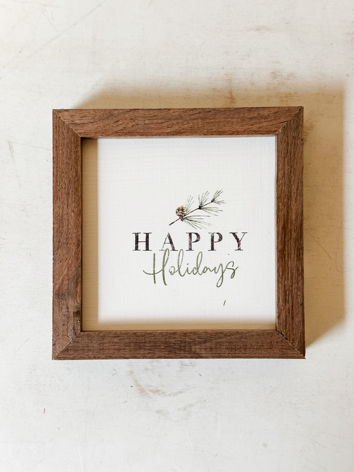 Mini wooden print of pine branch and Happy Holidays text at The Rustic Barn in Killingworth CT