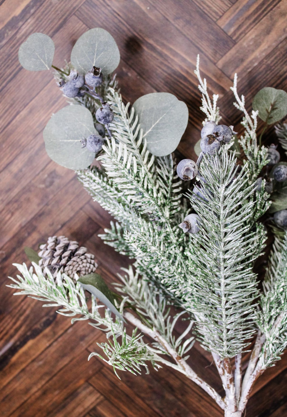Mixed pine winter greenery for the home with pinecones and blueberries and leaves for christmas and holiday decor with snow frosted pine leaves for sale at the rustic barn in Killingworth, CT