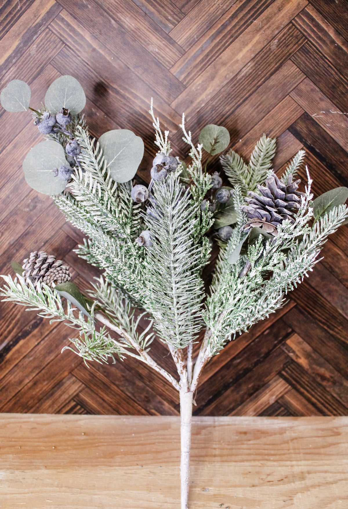 Mixed pine winter greenery for the home with pinecones and blueberries and leaves for christmas and holiday decor with snow frosted pine leaves for sale at the rustic barn in Killingworth, CT