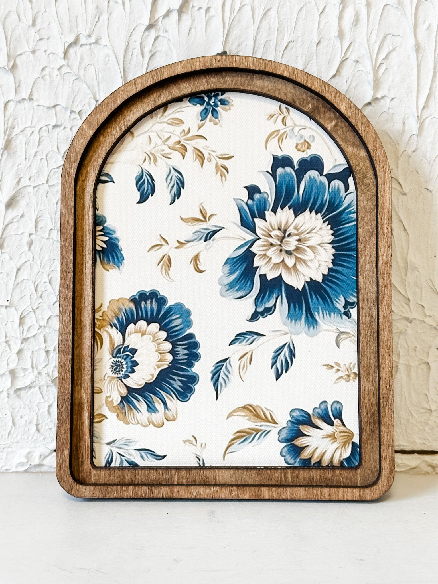 navy and tan arched framed artwork at the rustic barn in killingworth ct