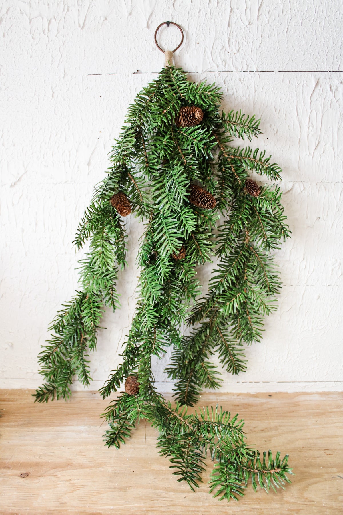 Oversized door swag with greenery and pinecones for Christmas and holiday decorating for sale at the rustic barn in Killingworth, CT