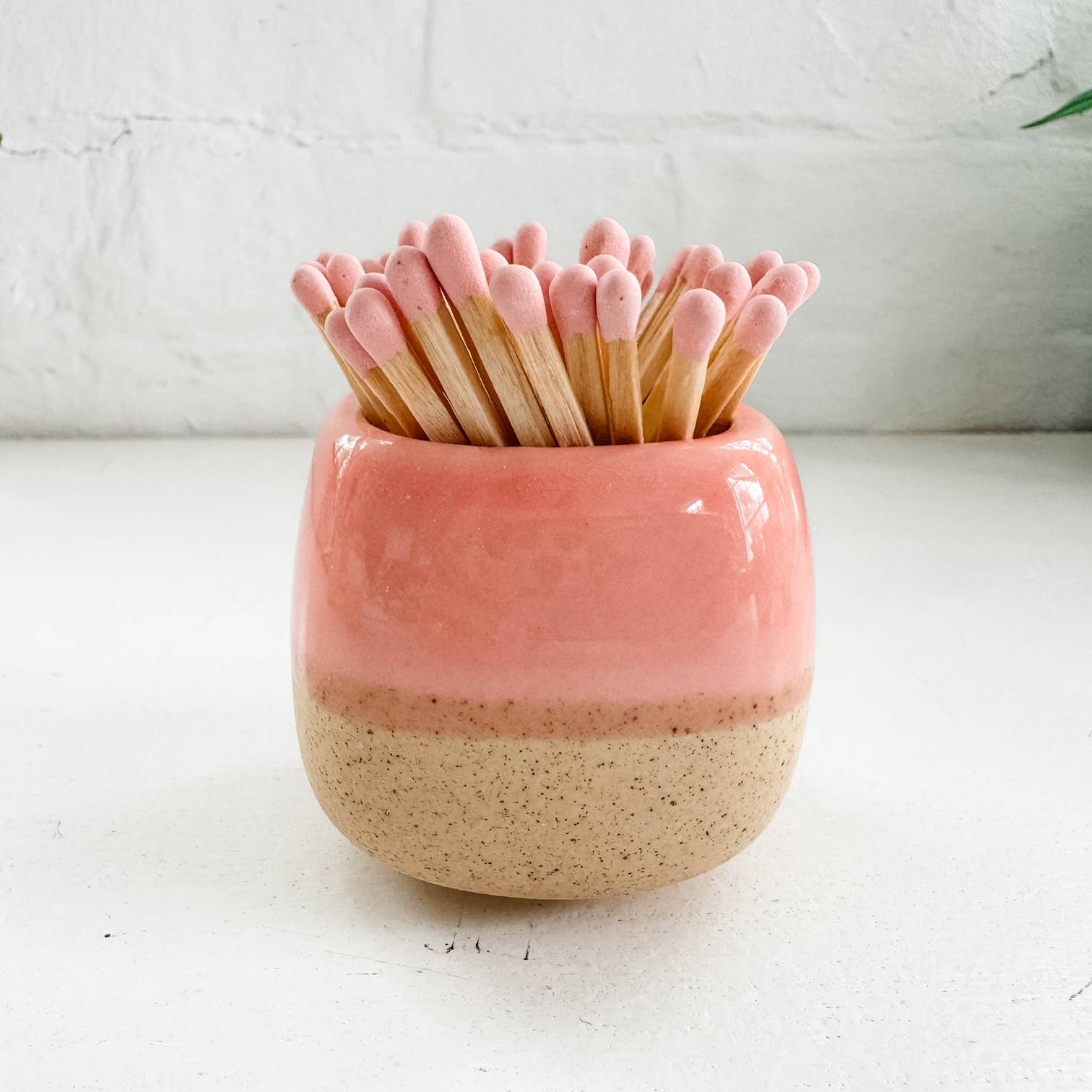 pink ceramic match holder with matches