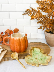 hand painted stoneware Pumpkin mug set featuring a teaspoon and leaf plate for fall at the rustic barn in killingworth, CT