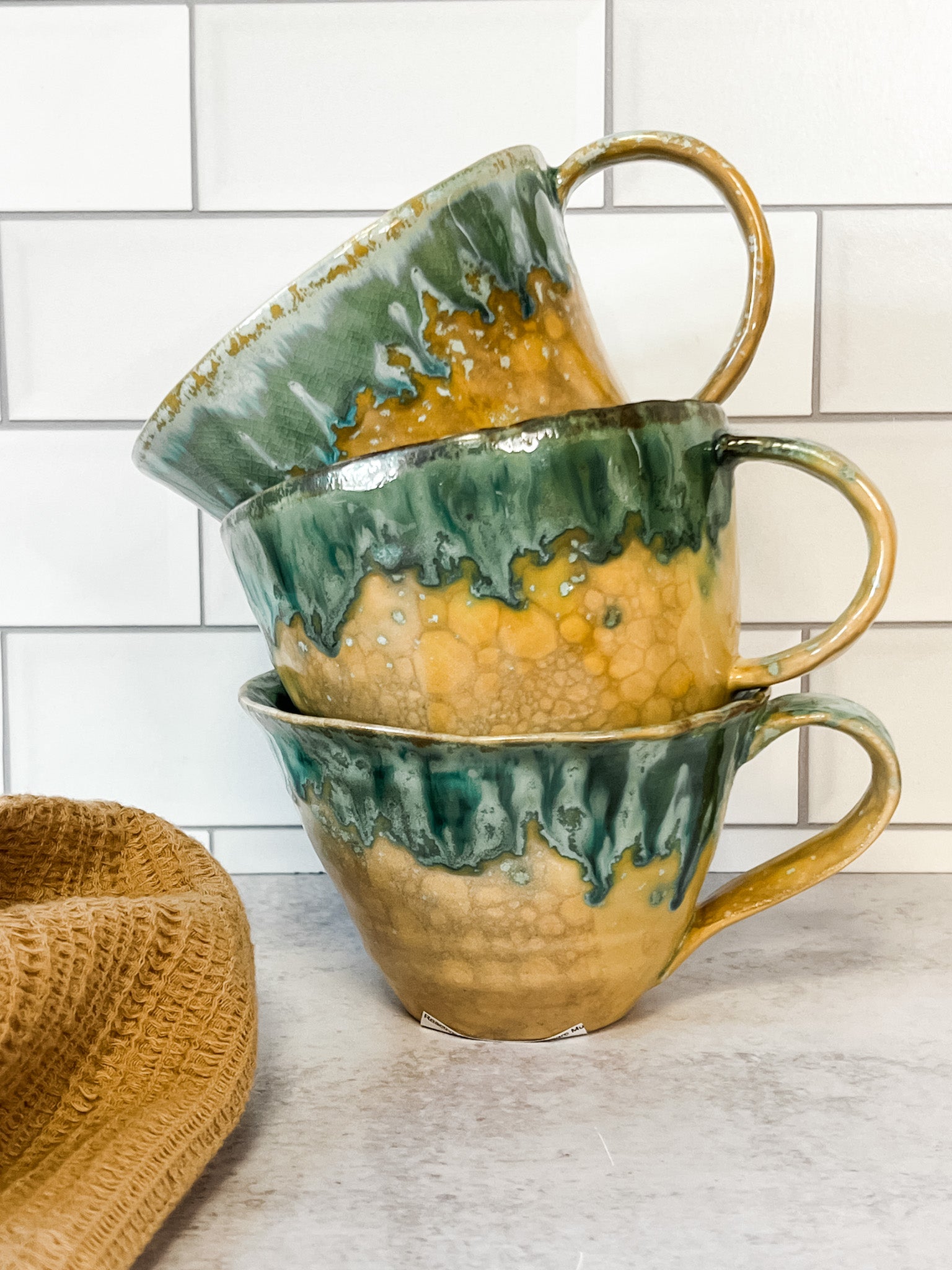 moss green stoneware mugs with reactive glaze at the rustic barn in killingworth ct