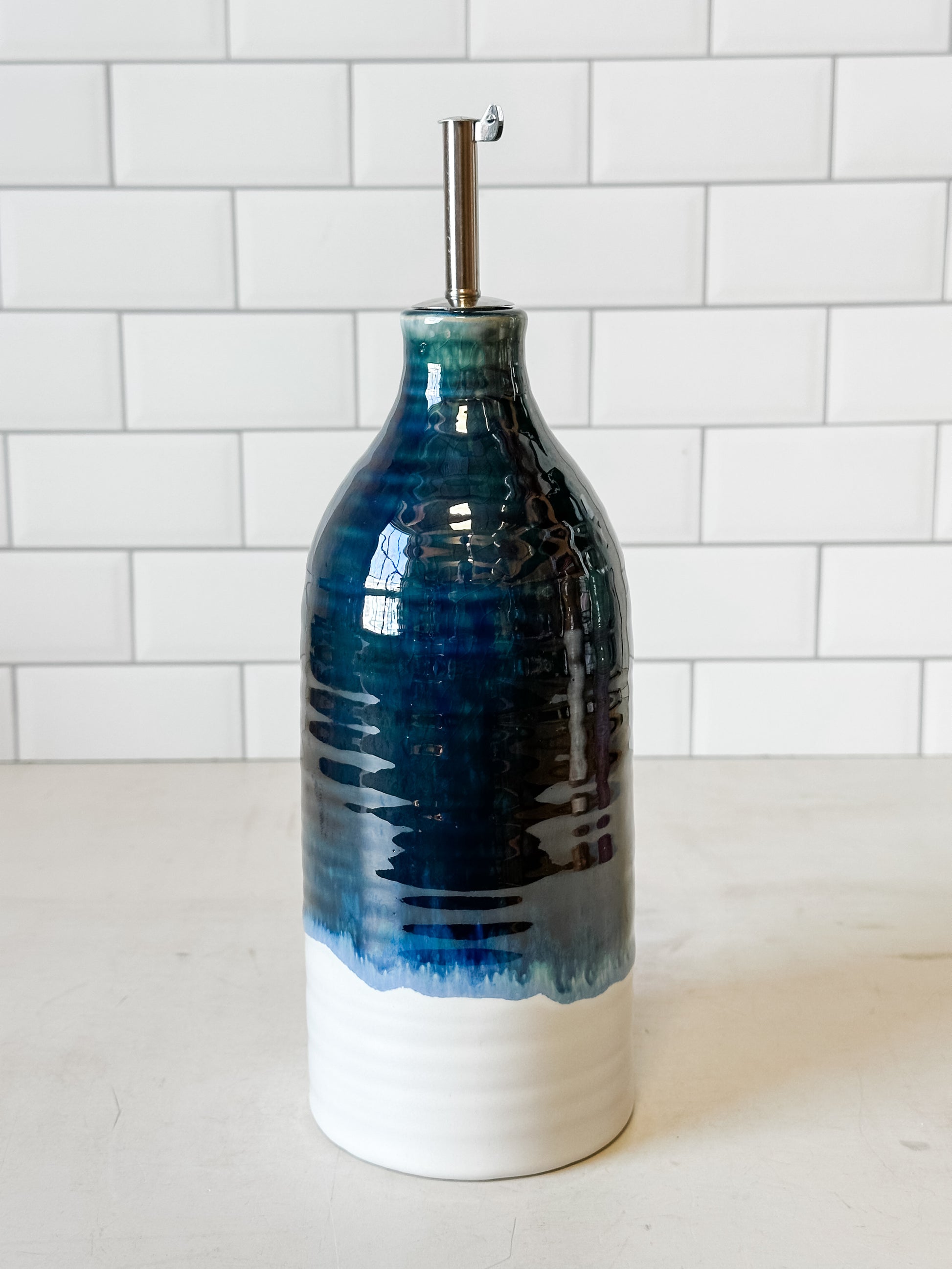 reactive glaze stoneware oil cruet with stainless steel spout at the Rustic Barn in Killingworth, CT