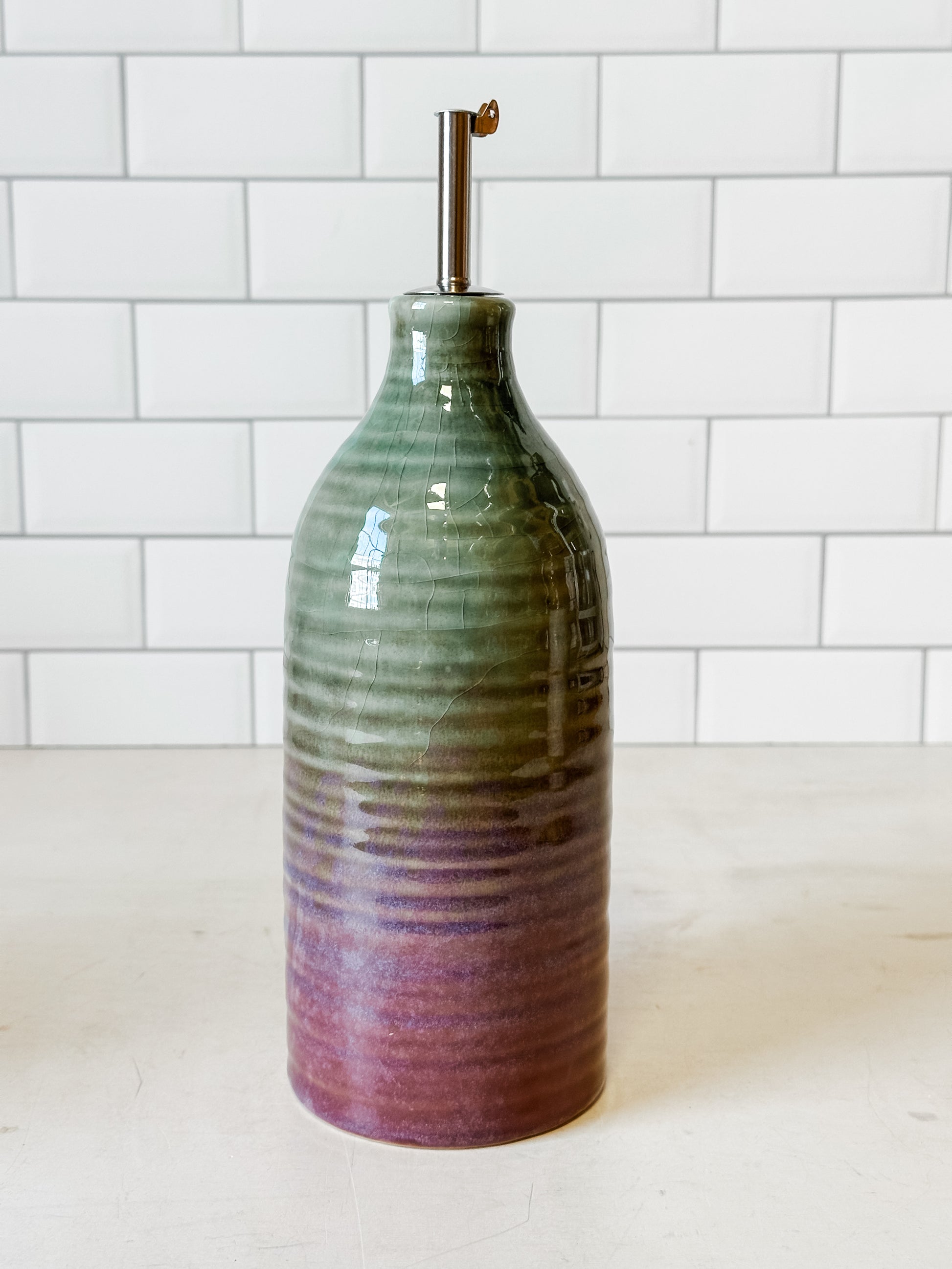 reactive glaze stoneware oil cruet with stainless steel spout at the Rustic Barn in Killingworth, CT