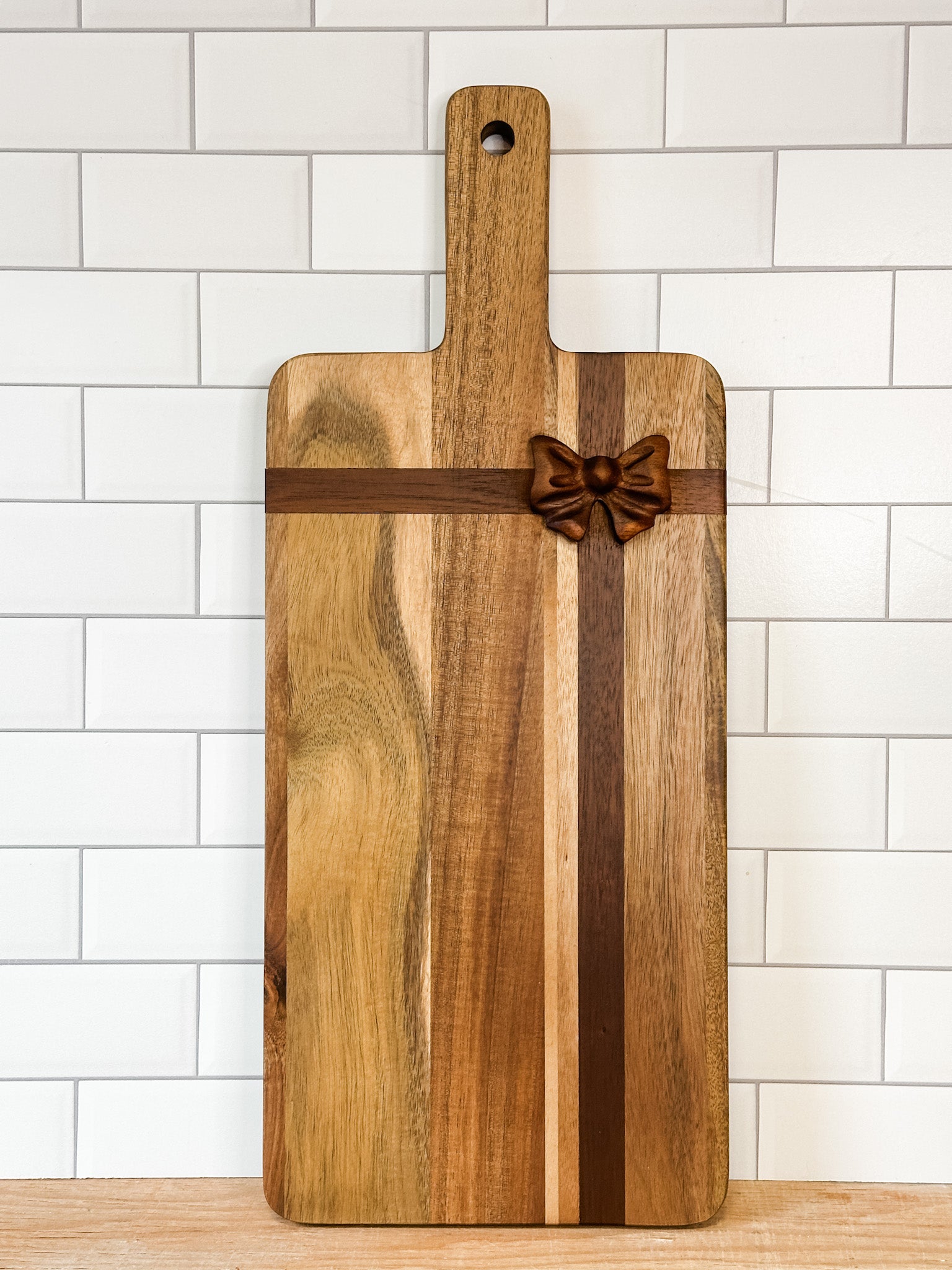 rectangle acacia wood cheese board with a bow on it at the rustic barn in Killingworth ct