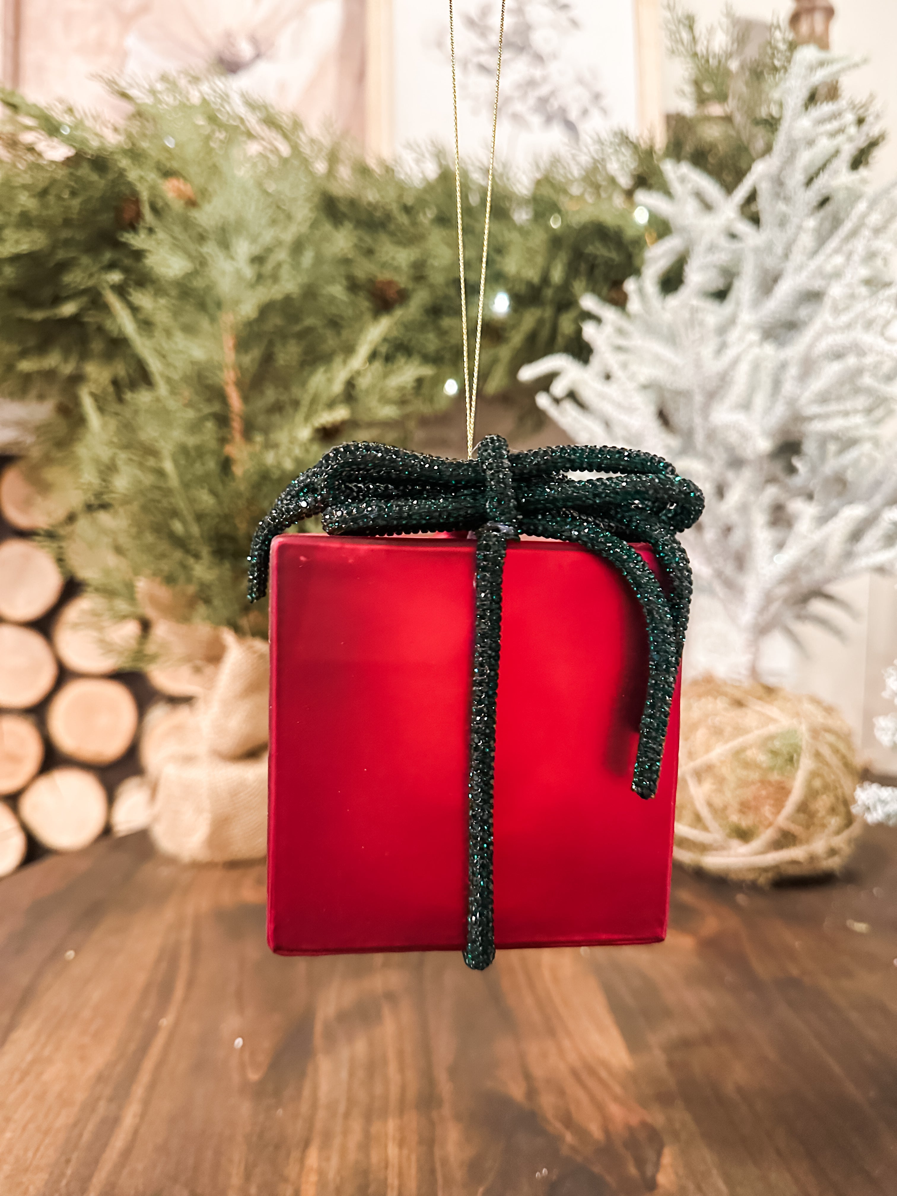 red glass present ornament with green glitter bow at The Rustic Barn in Killingworth CT