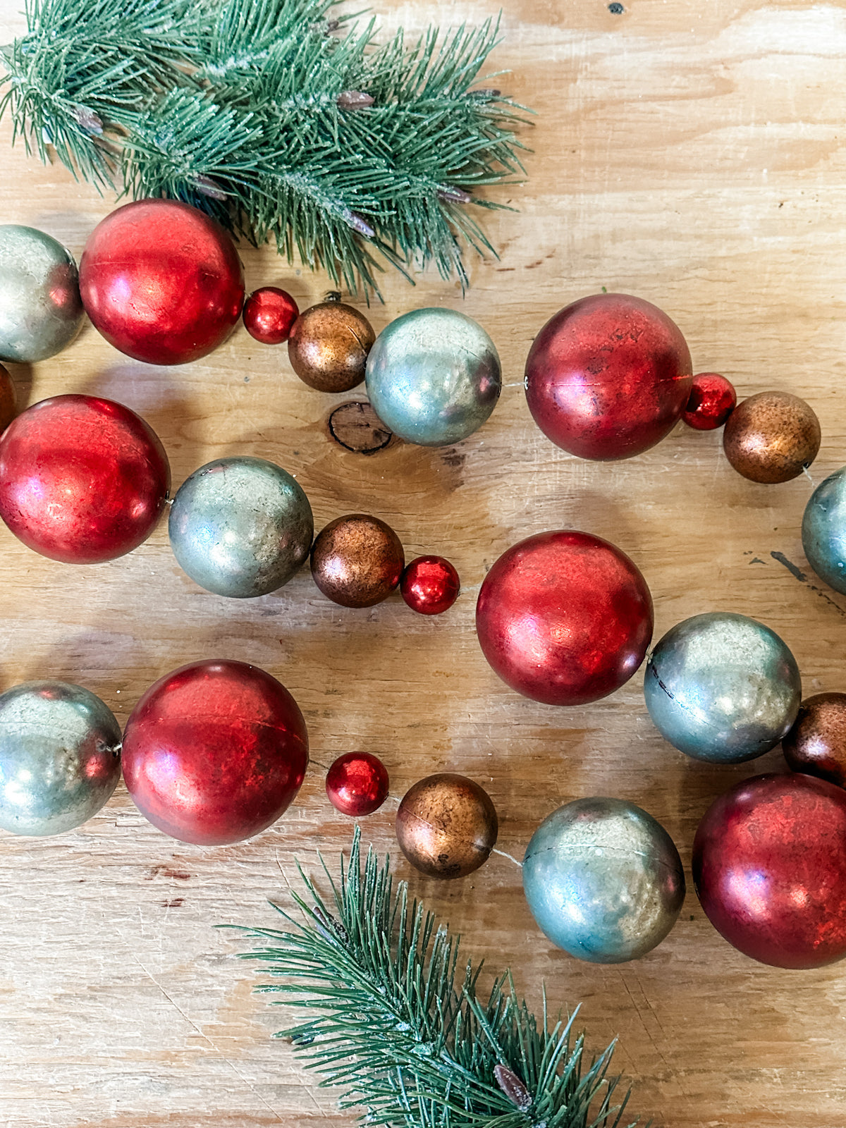 red green and rust colored christmas garland ornaments for sale at the rustic barn in killingworth, CT