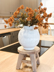 round natural wood riser pedestal stand at the rustic barn in killingworth ct