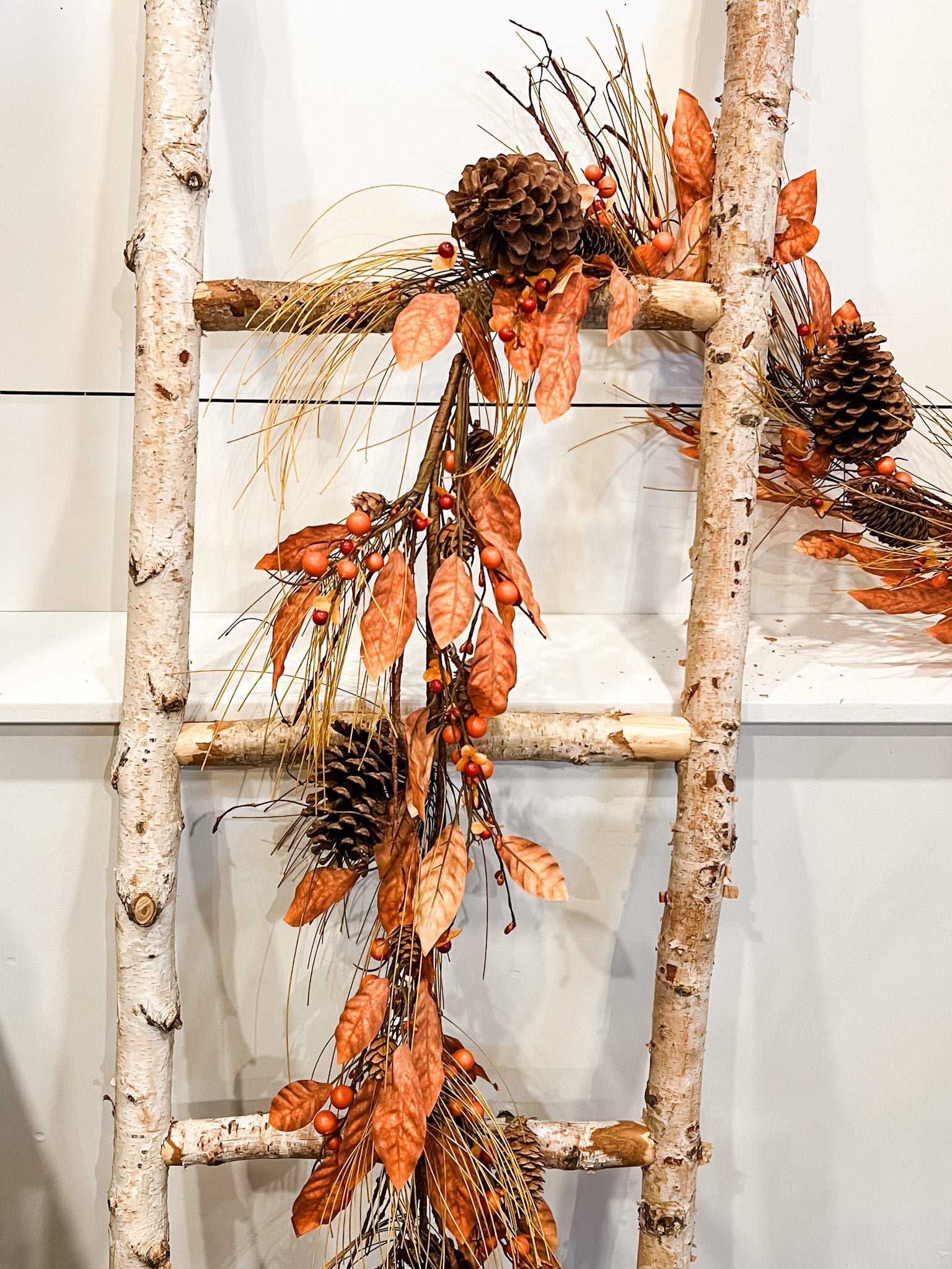 rustic orange pine and natural pinecone fall garland at the rustic barn in killingworth ct