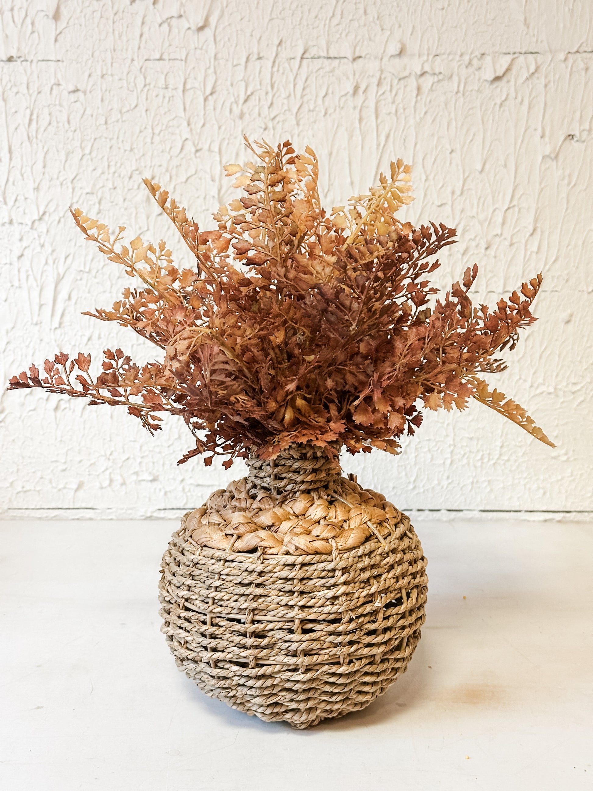 small seagrass woven vase with faux florals at the Rustic Barn in Killingworth CT