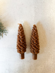 set of two brown pinecone taper candles at the rustic barn in killingworth ct