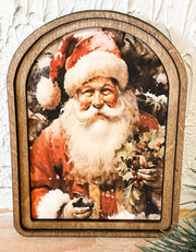 small arched frame of santa holding holly at the rustic barn in killingworth ct