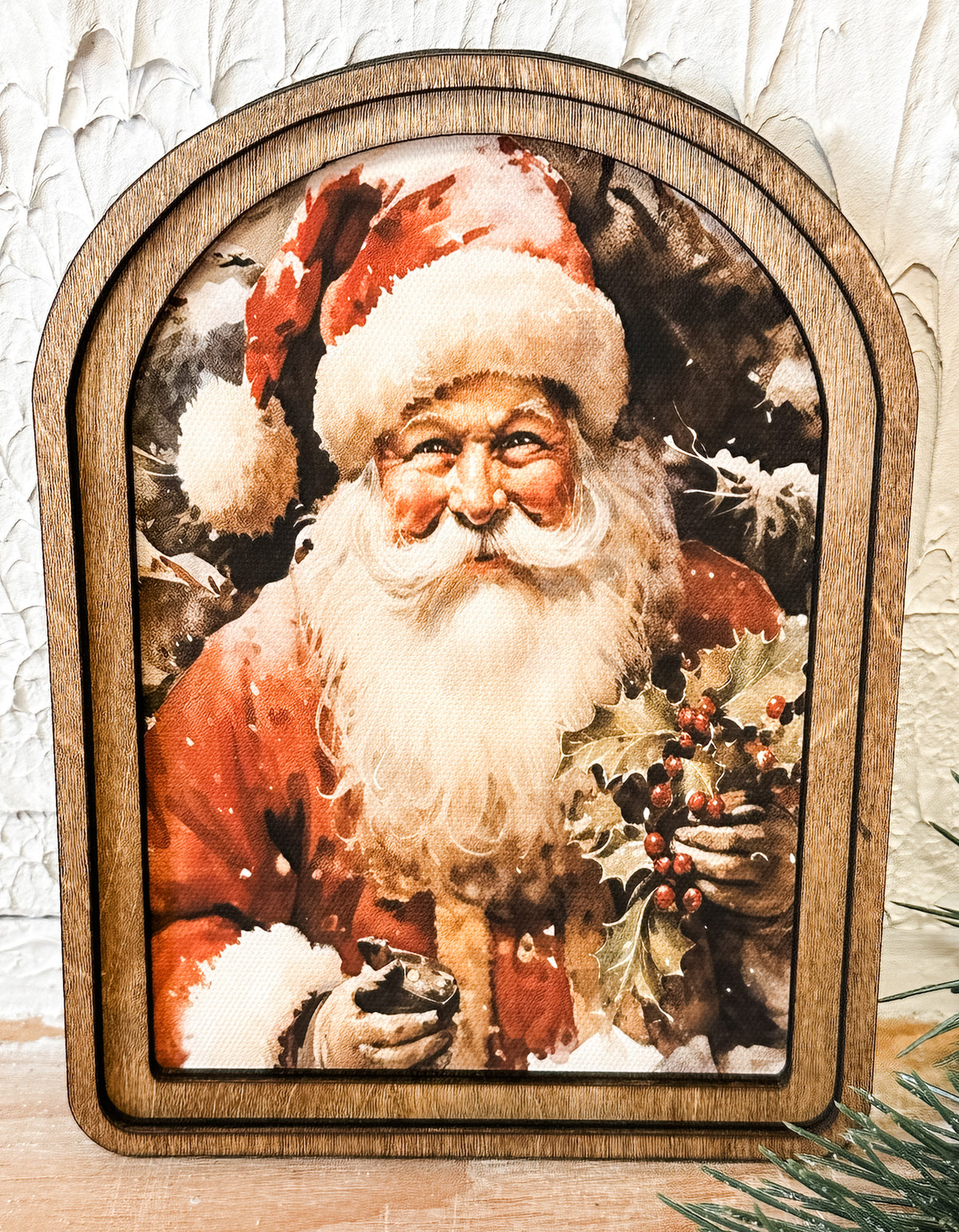 small arched frame of santa holding holly at the rustic barn in killingworth ct