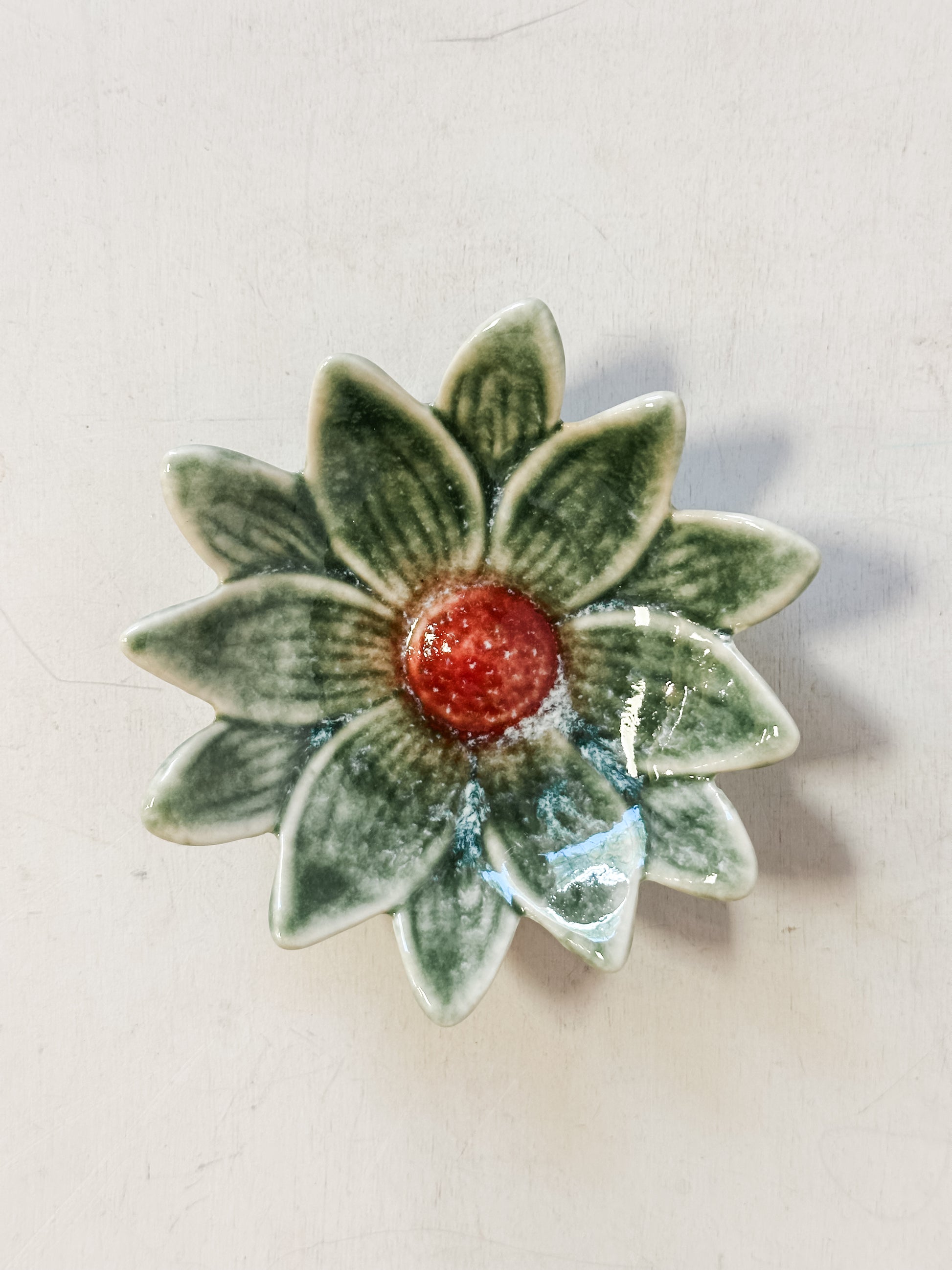 small dark green stoneware flower shaped dishes at The Rustic Barn in Killingworth CT