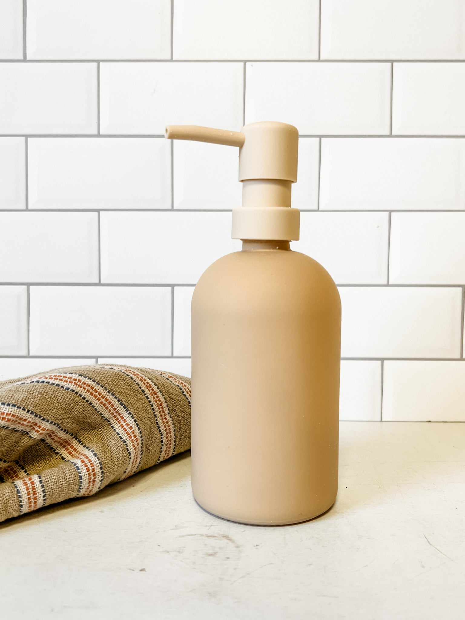soft peach color glass soap dispenser at the rustic barn in killingworth ct