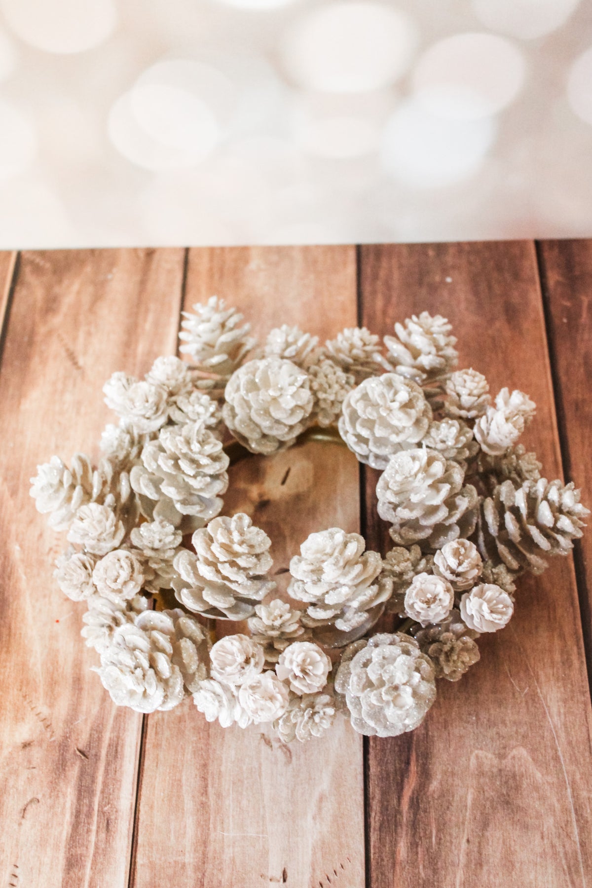 Sparkling ivory pinecone candle ring bright whites sparkly for sale at the rustic barn in Killingworth, CT