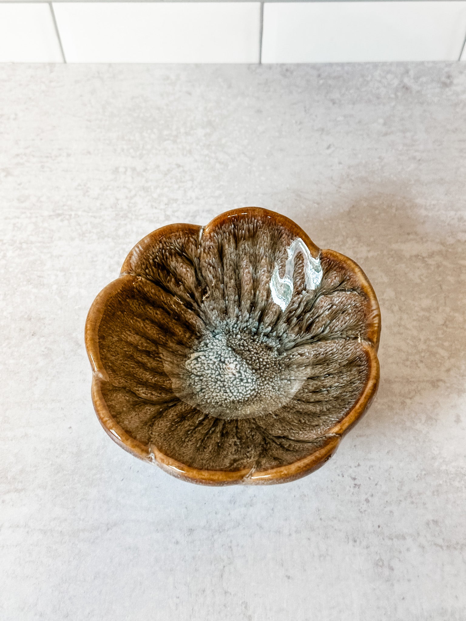 small stoneware flower bowl with unique reactive glaze markings at the rustic barn in killingworth ct