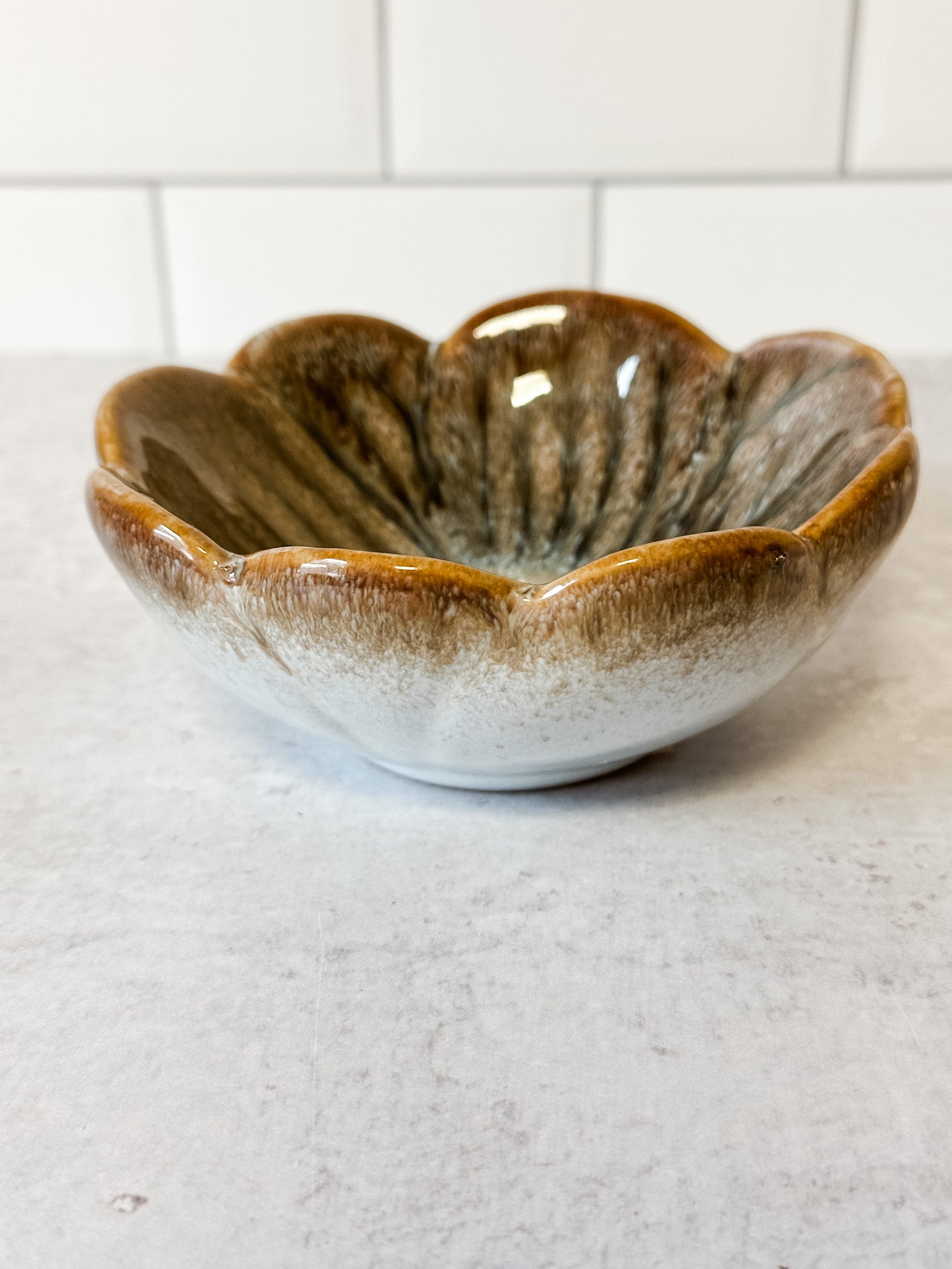 small stoneware flower bowl with unique reactive glaze markings at the rustic barn in killingworth ct