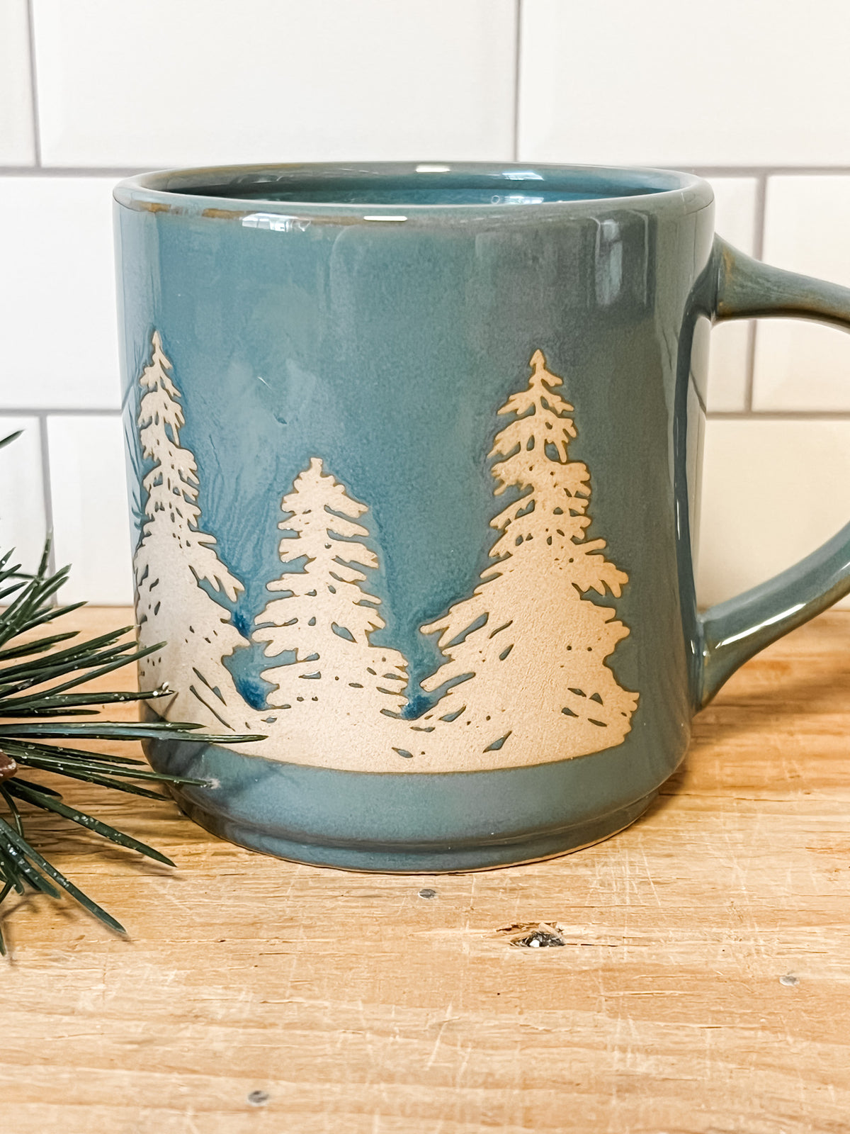 stoneware mug with wax relief trees blue color at the rustic barn in Killingworth ct