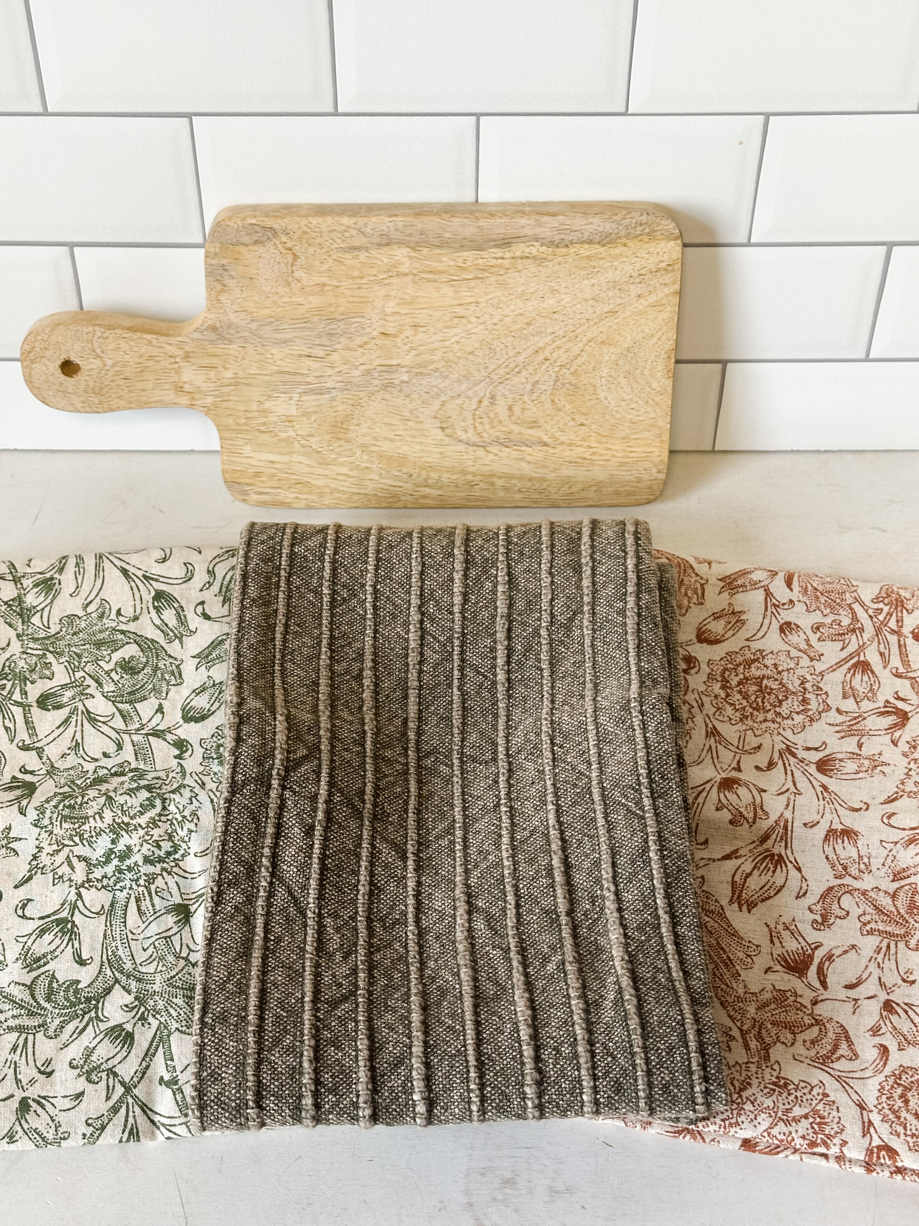 stonewashed cotton tea towels and mango wood serving board set at the Rustic Barn in Killingworth, CT