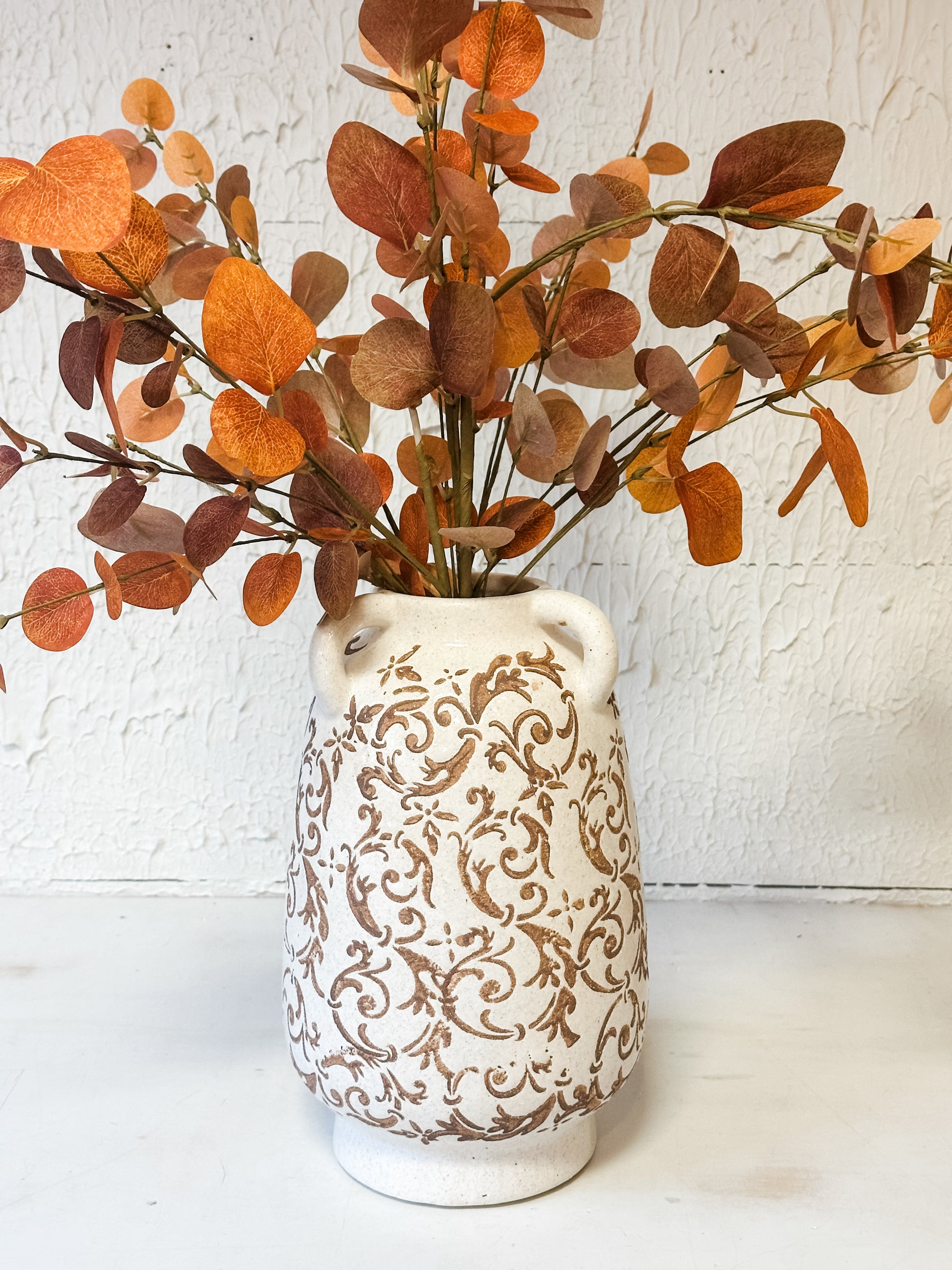 tan and cream ceramic vase with floral print and faux florals at The Rustic Barn in Killingworth CT
