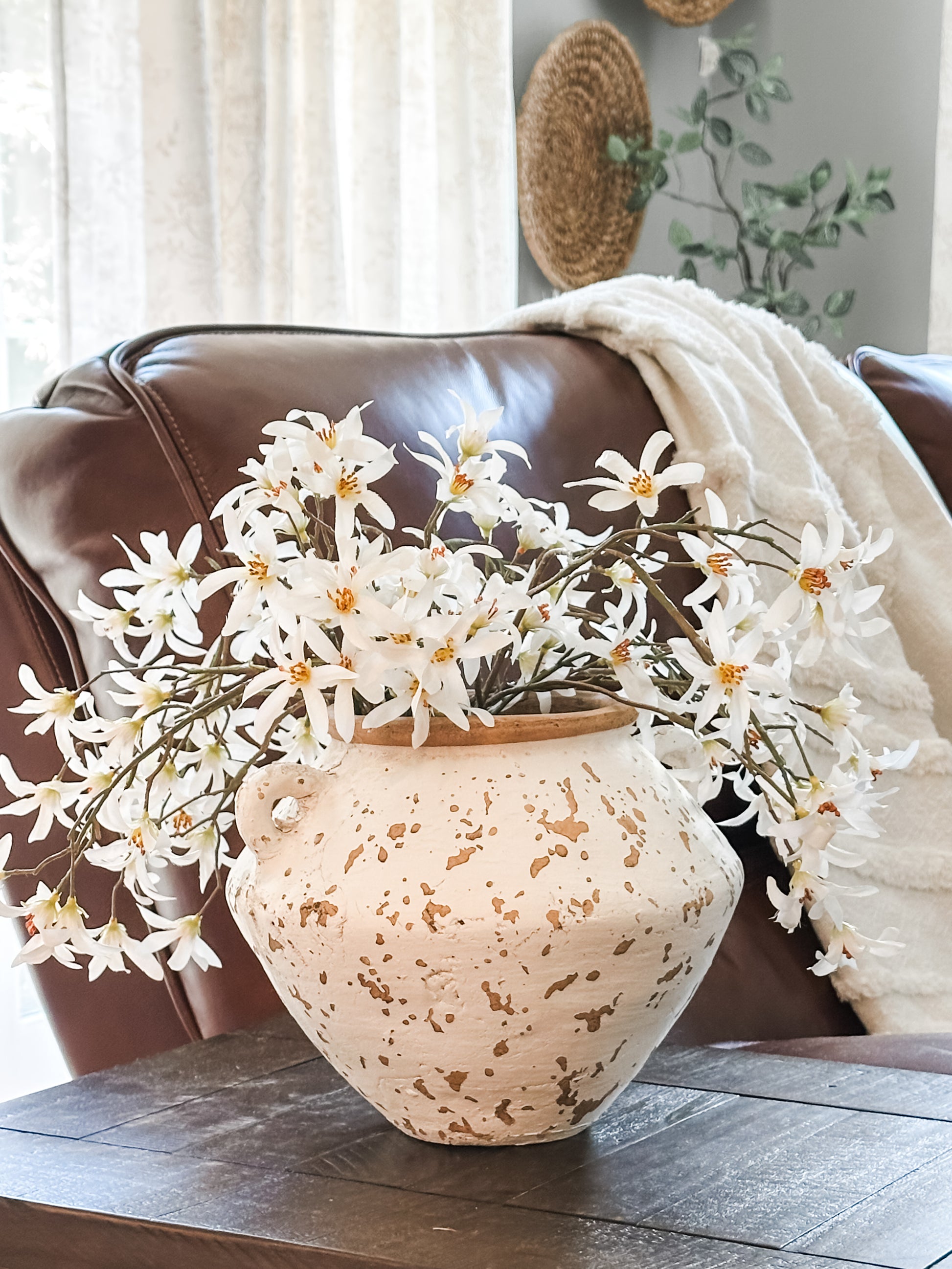 two handle terracotta vase styled in a living room with faux florals at the Rustic Barn in Killingworth CT