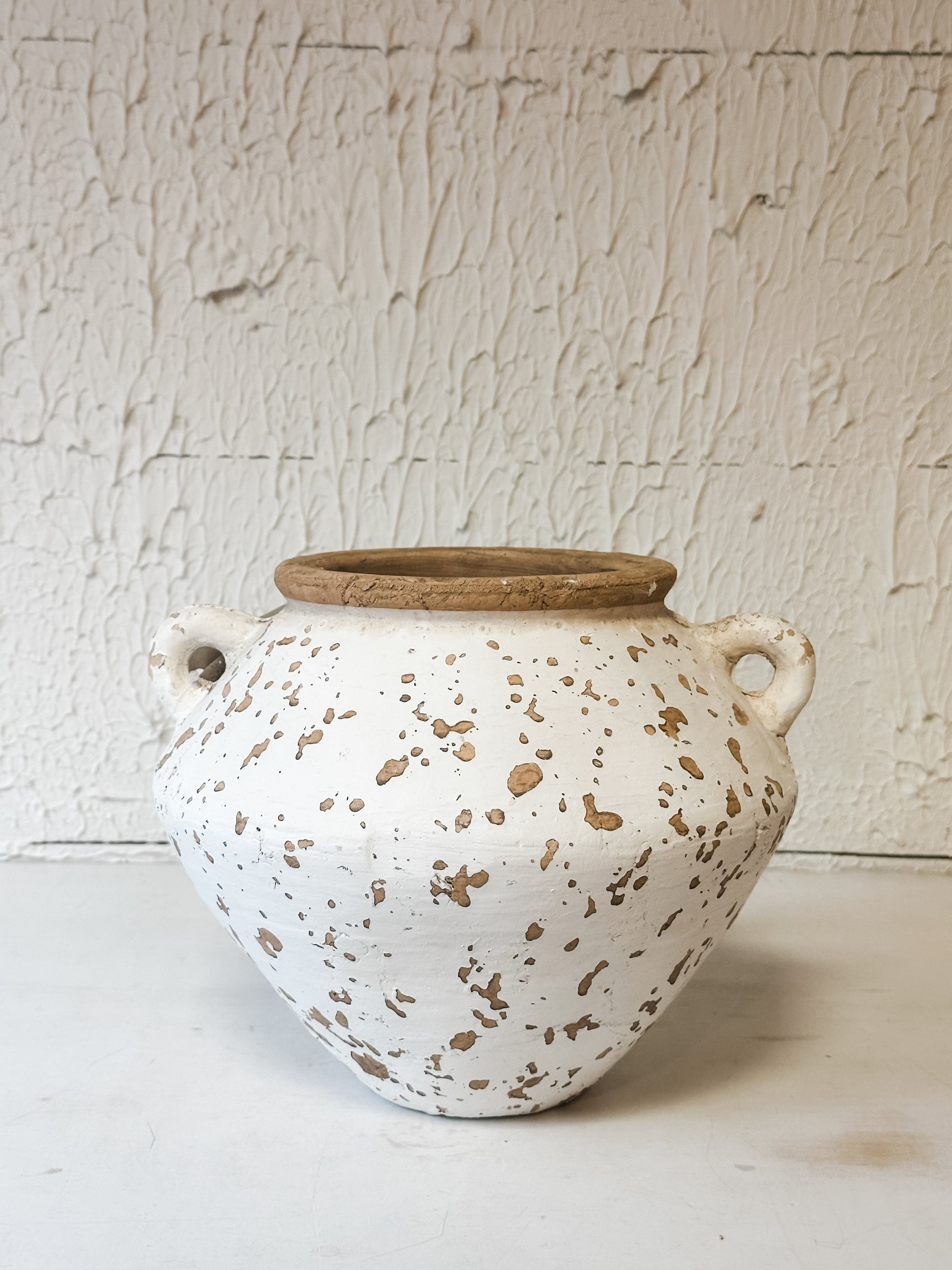 two handle terracotta vase styled in a living room with faux florals at the Rustic Barn in Killingworth CT