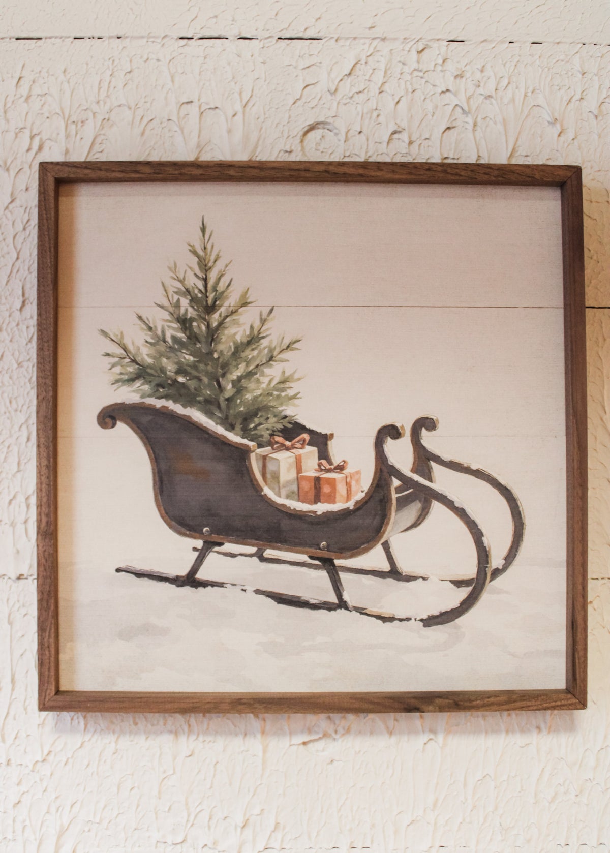 vintage black christmas sleigh in snowy scene with Christmas tree and gifts for holiday wall room decor print for sale at the rustic barn in killingworth, CT