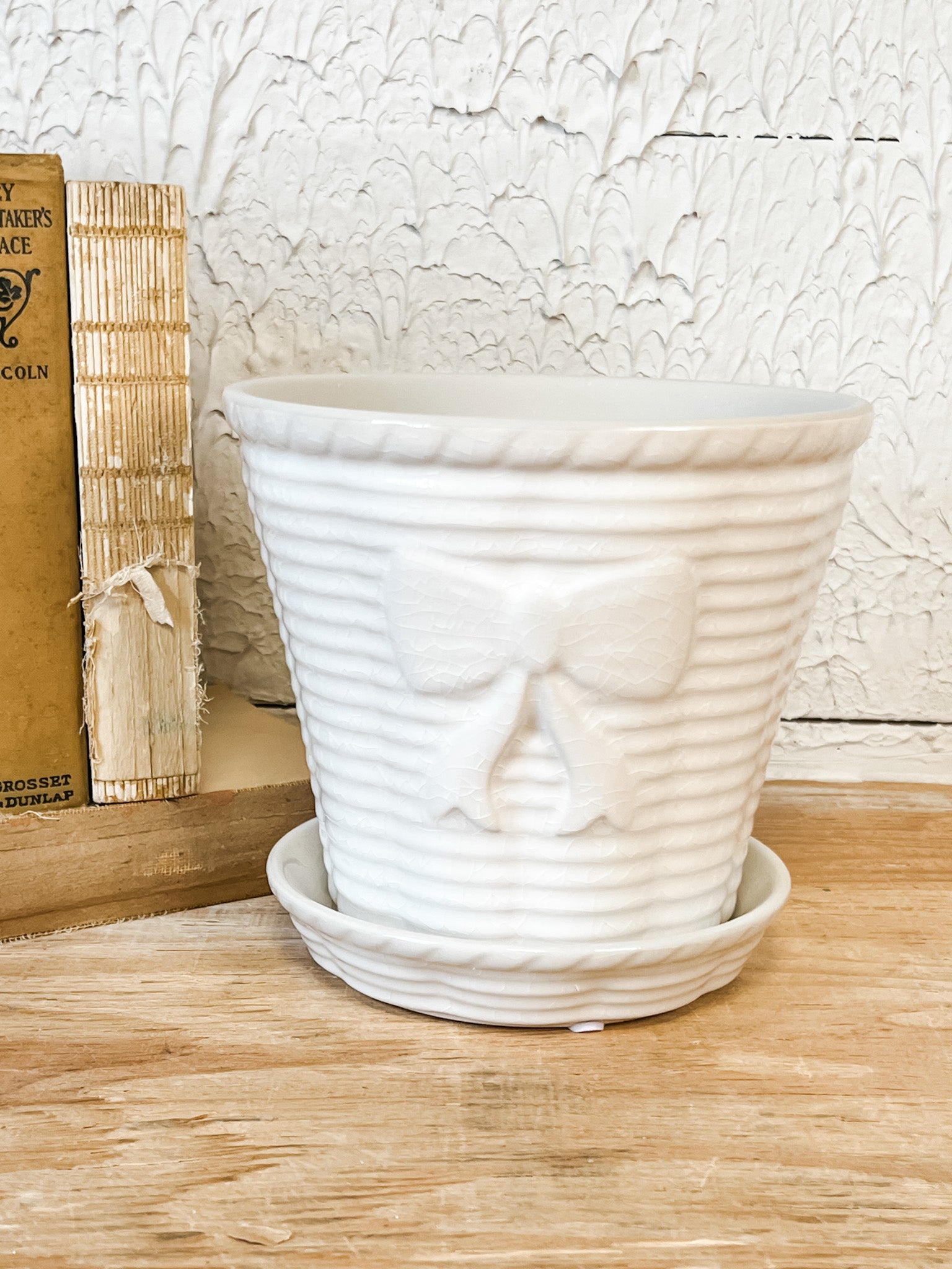 vintage stoneware planter with bow and saucer at the rustic barn in killingworth ct