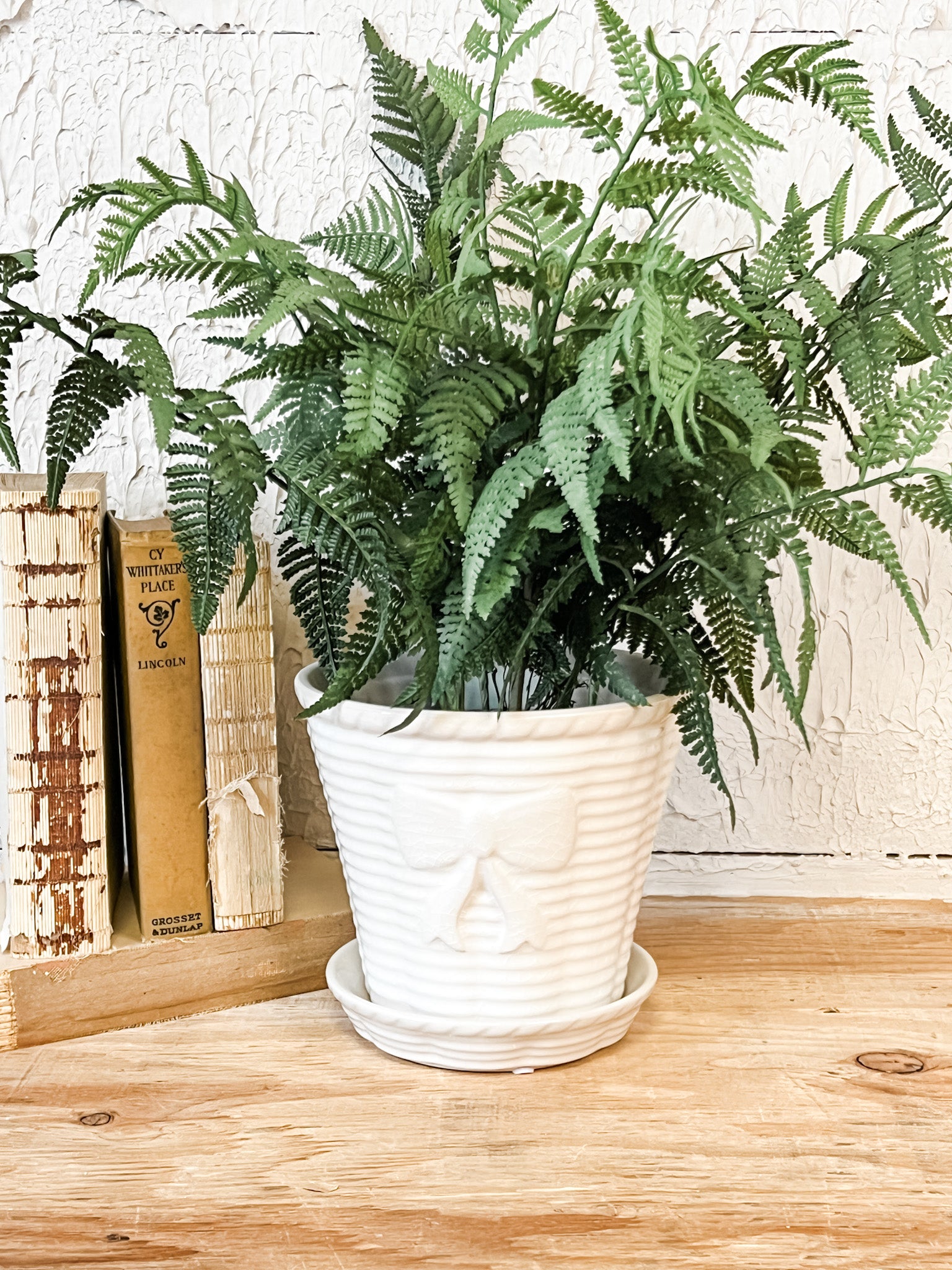 vintage stoneware planter with bow and saucer at the rustic barn in killingworth ct