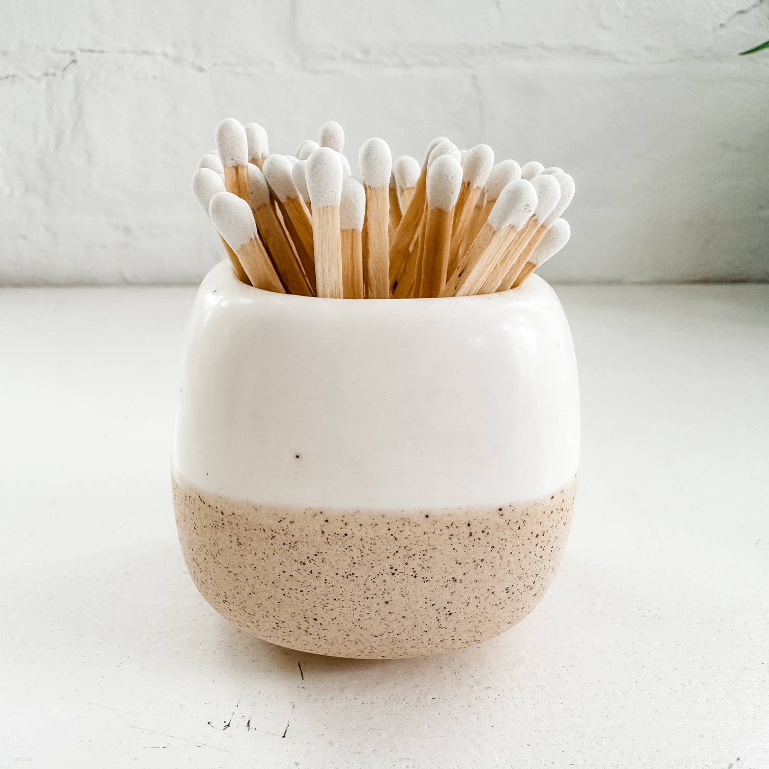 white ceramic match holder with matches