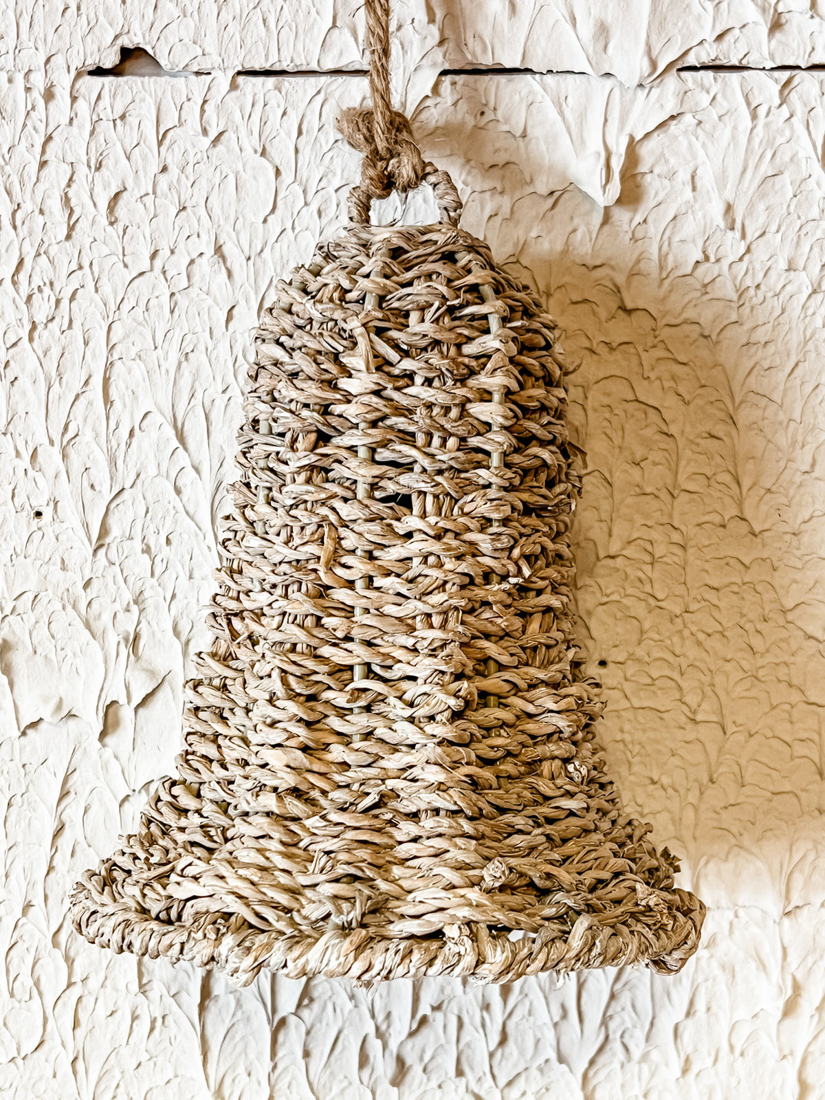 white washed rattan bell ornament at the rustic barn in killingworth ct