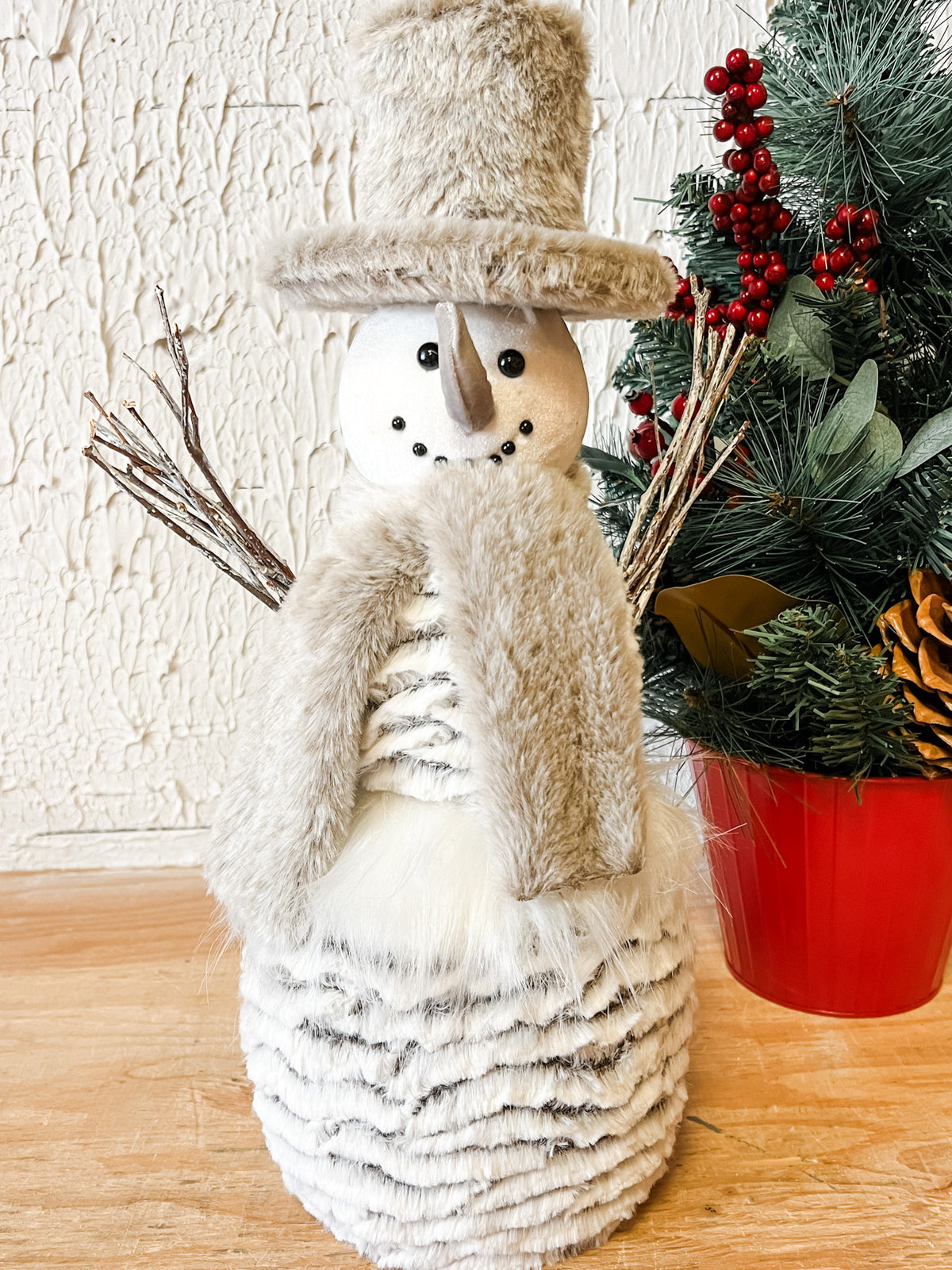 grey and white snowman with hat scarf and stick arms at the rustic barn in killingworth ct