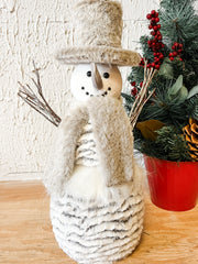 grey and white snowman with hat scarf and stick arms at the rustic barn in killingworth ct