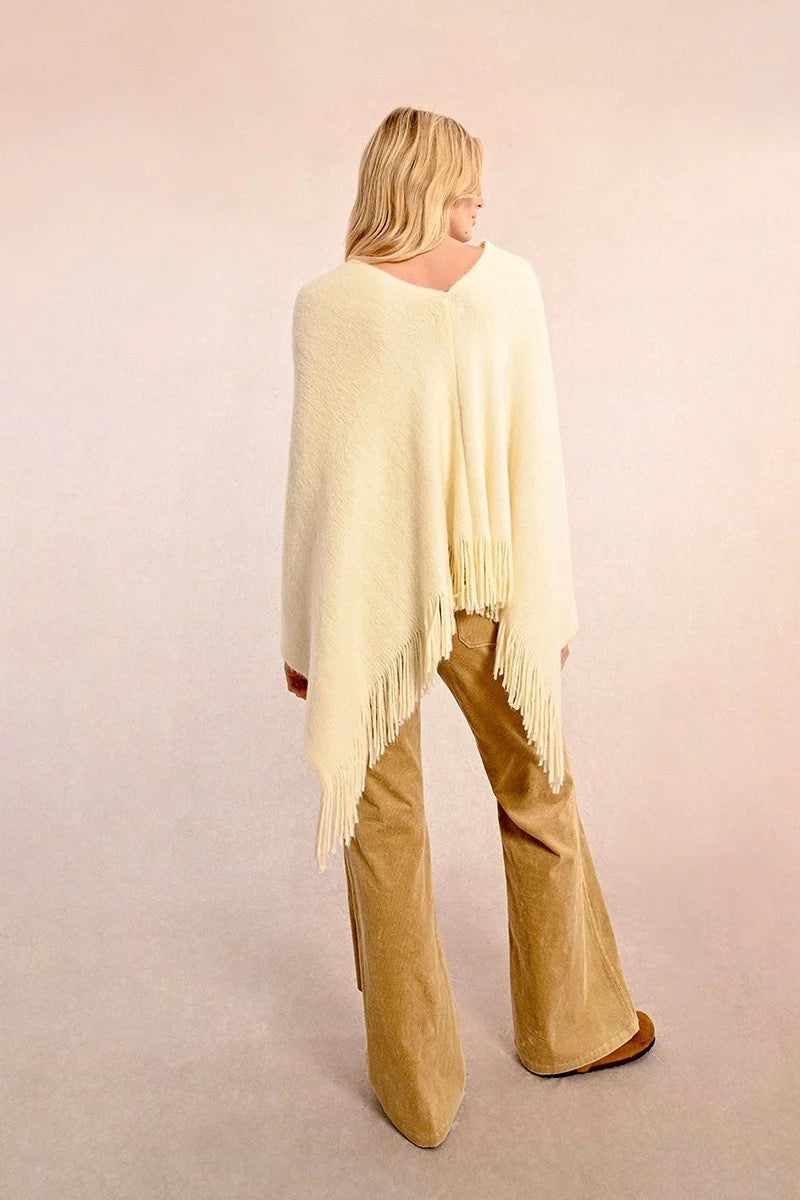 Cream colored cozy fall or winter poncho with fringe detail for sale at the rustic barn in killingworth, CT