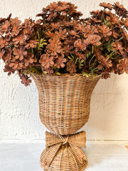 woven rattan footed floral container with a bow at the rustic barn in killingworth ct