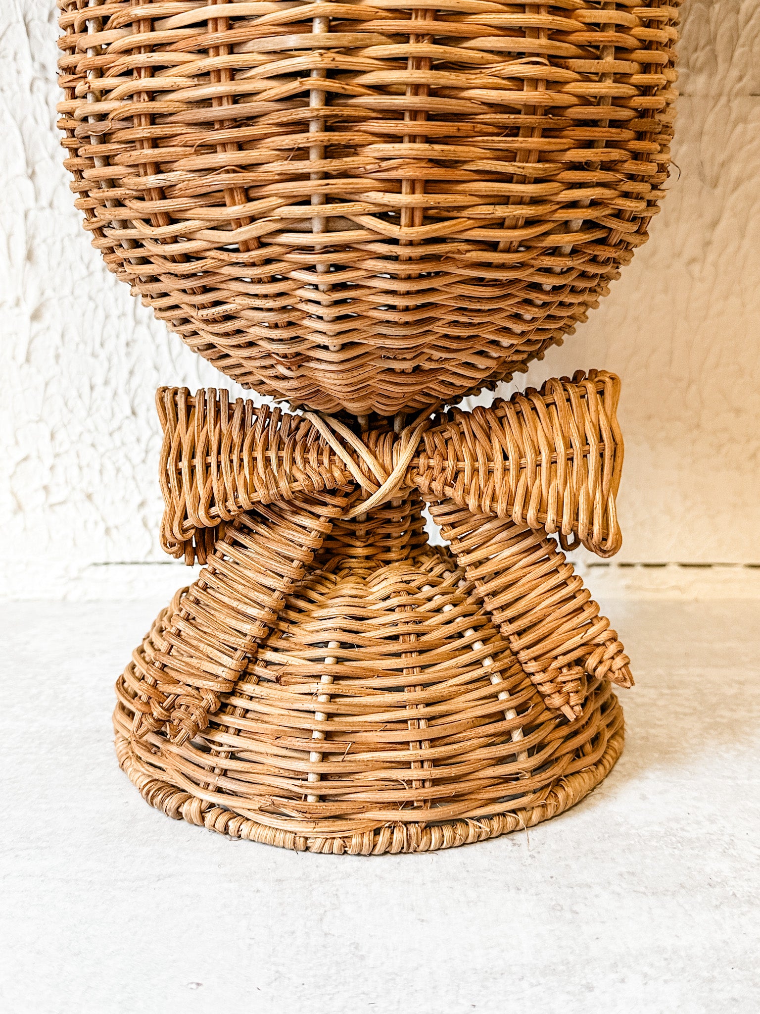 woven rattan footed floral container with a bow at the rustic barn in killingworth ct